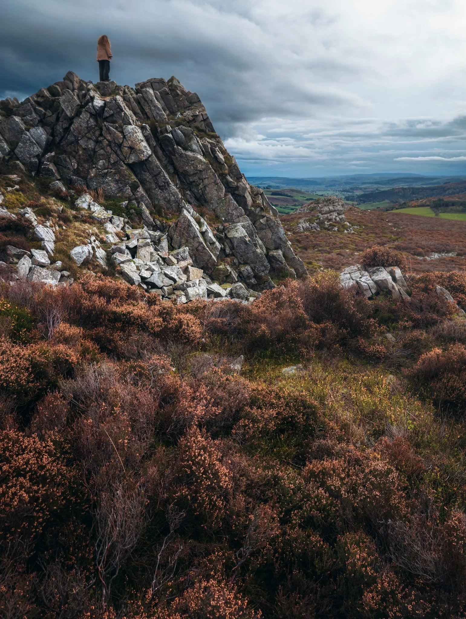  Lisabet was feeling brave so she scrambled to the top of Cranberry Rock. A brief burst of light gave me this nice scene made of the last of the year&rsquo;s heather blossom and Lisabet perched on top of Cranberry Rock. 