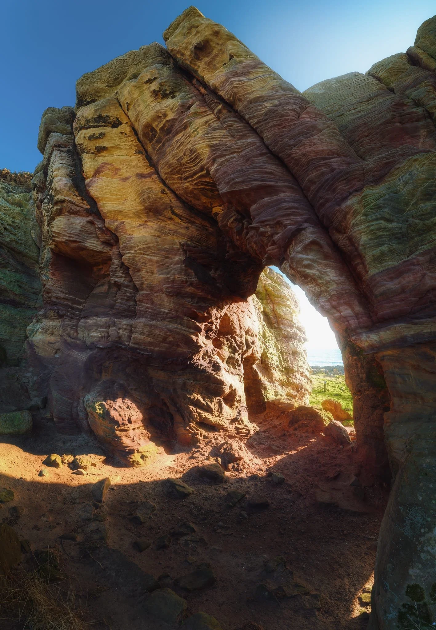  Similarly, this time from behind the largest cave, I shot six landscape photos stacked top to bottom to achieve this mind-bending vertorama composition. The low morning sun blasted light through the opening, pulling out all the gorgeous textures and colours. 