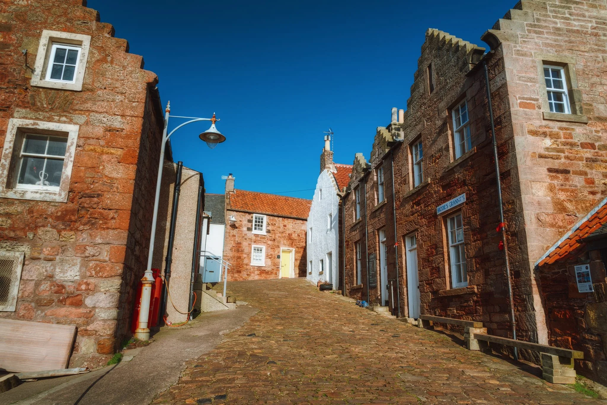  Looking up the still-cobbled King Street. Here another architectural characteristic of eastern Scottish buildings becomes visible: crow-stepped or &ldquo;corbie&rdquo; stepped gable-ends. The term &ldquo;corbie steps&rdquo; is more common in Scotland; the Scots word &ldquo;corbie&rdquo; meaning &ldquo;crow. We probably nicked this design idea from Belgium and the Netherlands. 