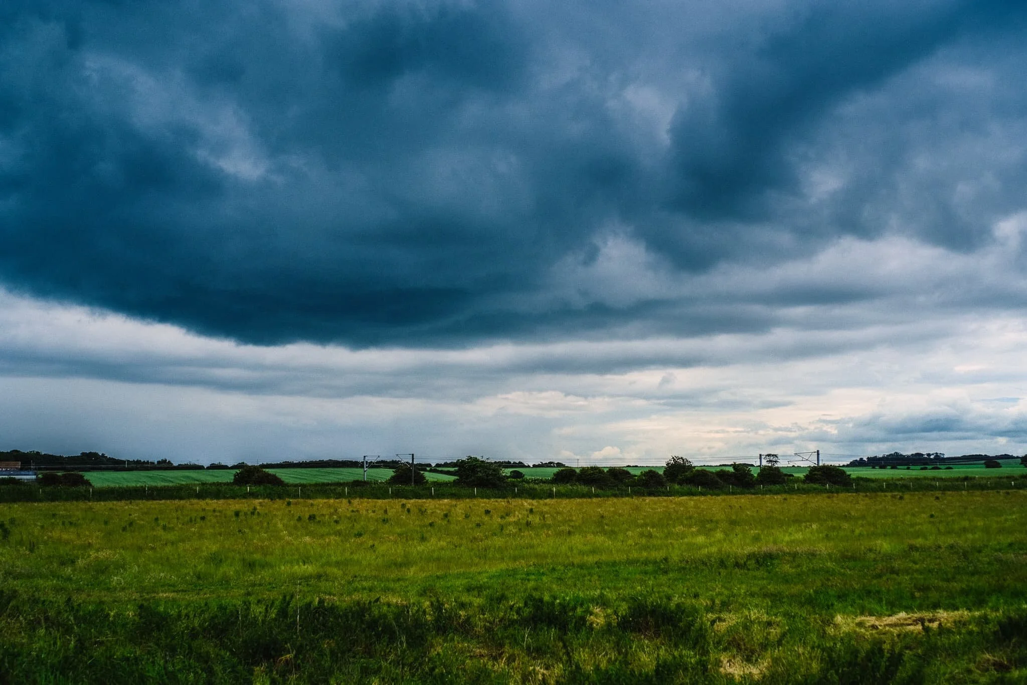  After escaping the rains falling over Bamburgh and inland Northumberland, we drove north to visit a relatively little-known beach called Cheswick Sands. I snapped the rather dramatic skyline from the car park. Good job we weren&rsquo;t under that. 