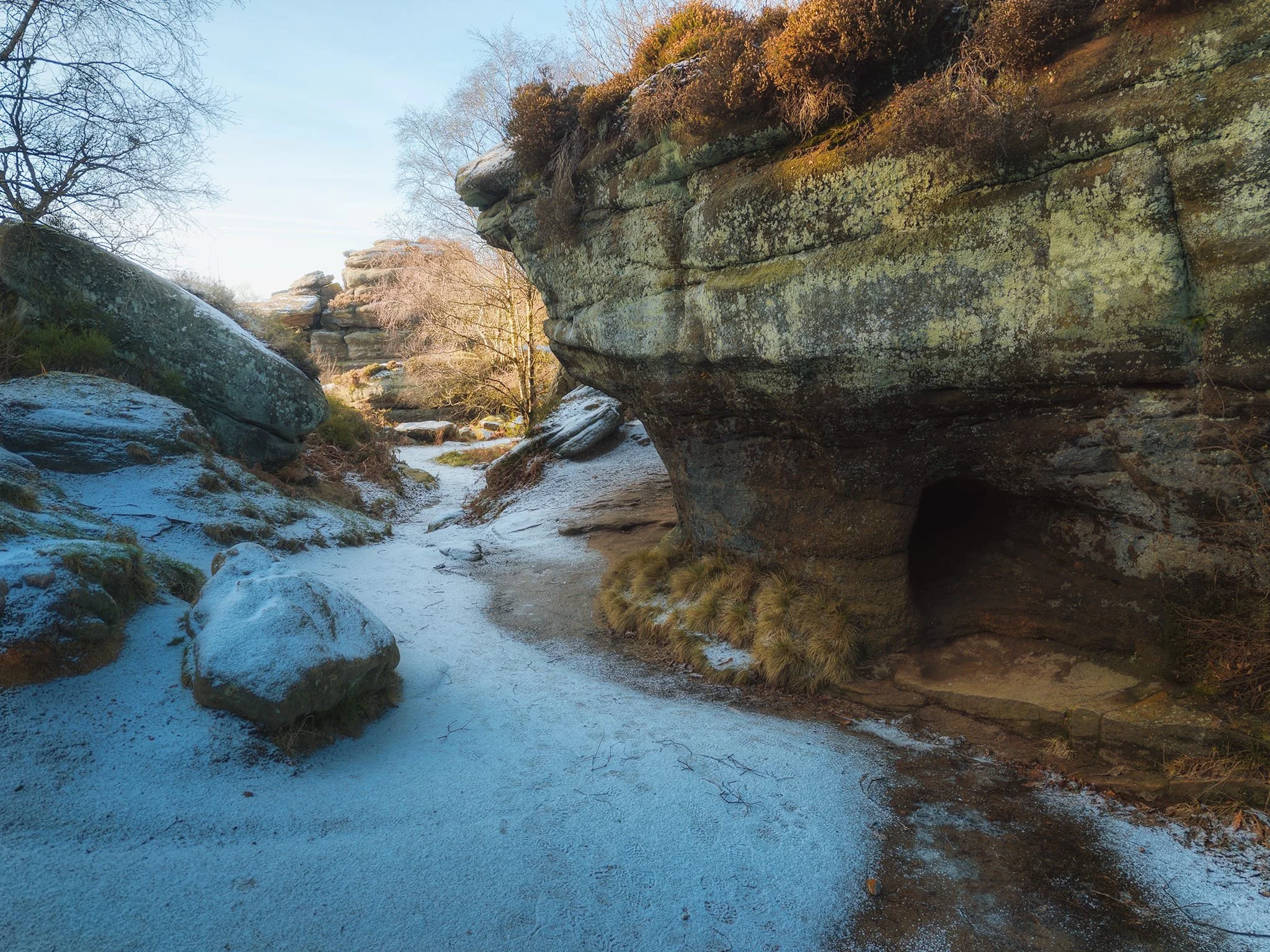  Round the back of the Eagle, towards Lover&rsquo;s Leap, a small valley retains the cold, freezing the beck. This is also where you can find this formation, with a natural tunnel cutting through it.  