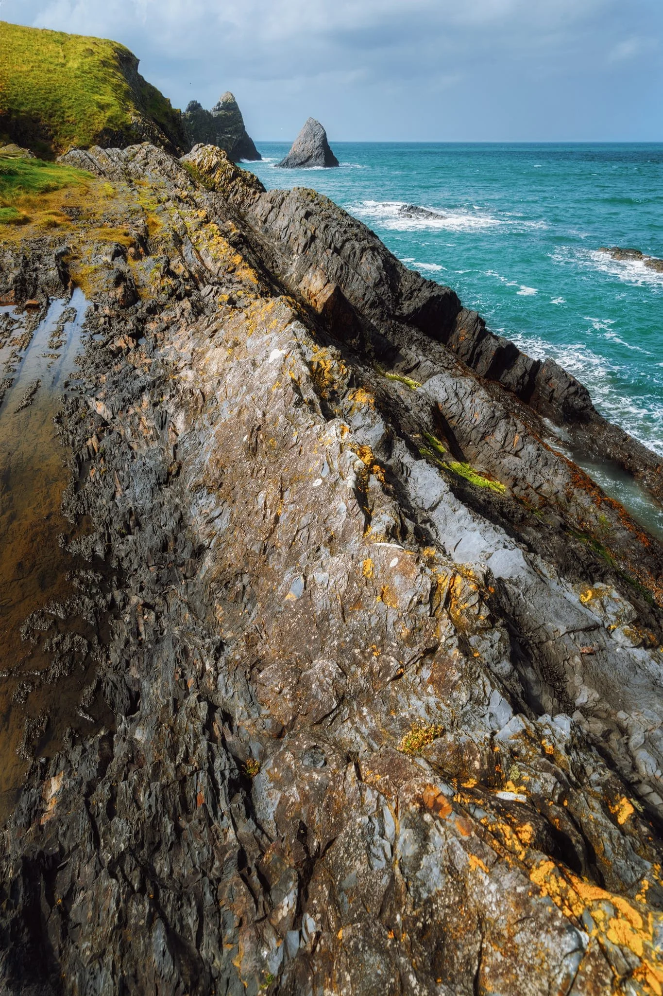  A particularly sharp fold served as a dominant leading line towards the two shark fin sea stacks of  Careg Wylan . 