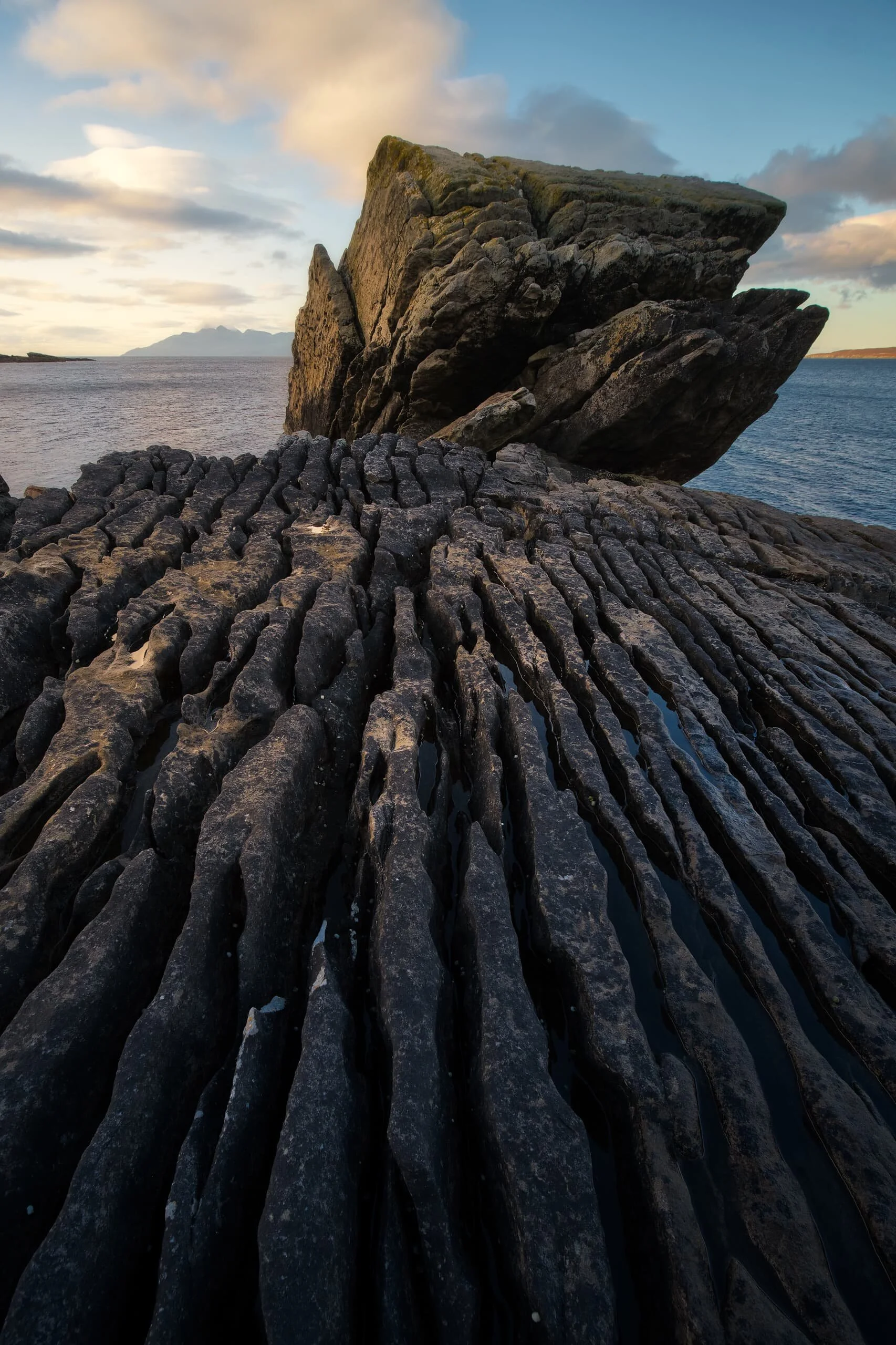  I found this particularly large rock formation, about the size of a small car, all jagged and seemingly resting on the raised platform. Thousands of years of action from the sea has cut grooves into the raised bed, which I took advantage of for a composition. 