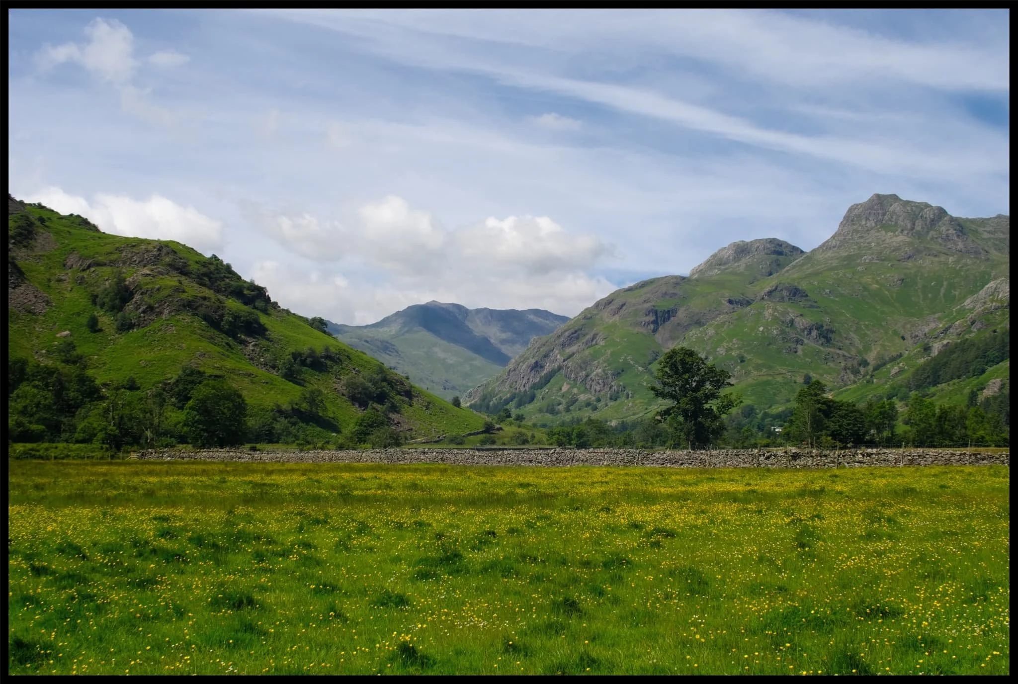  The first leg of the hike I wanted to explore was to head east towards Oak Howe. This part of Great Langdale is heavy with summer meadows and at this time of the year they&rsquo;re brimming with flowers. Plus, you get panoramas like this. 