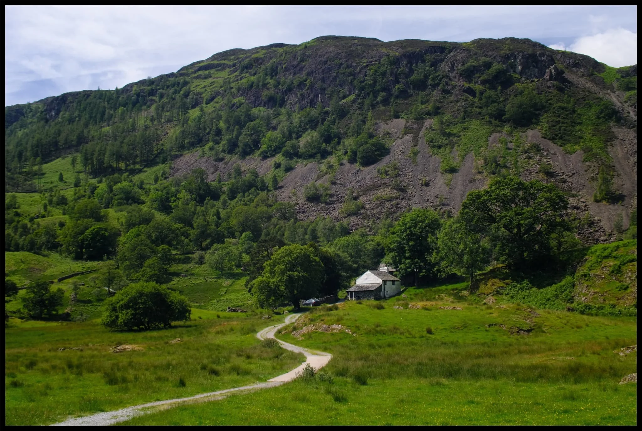  Oak Howe cottage, with Oakhowe Crag towering above, itself a subsidiary top of Lingmoor Fell. 