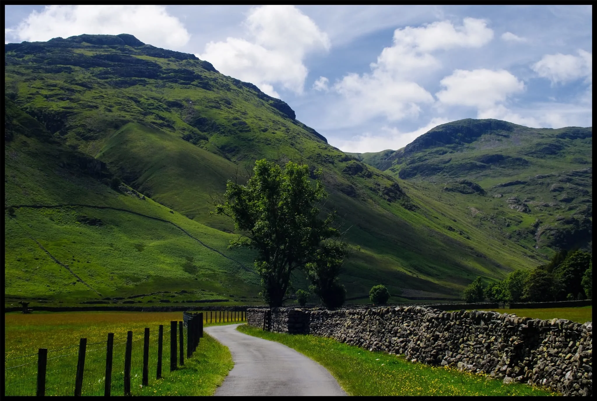  As I head closer to Stool End Farm, Pike o&rsquo; Blisco (705 m/2,313 ft)—south of Crinkle Crags—makes its presence known. 