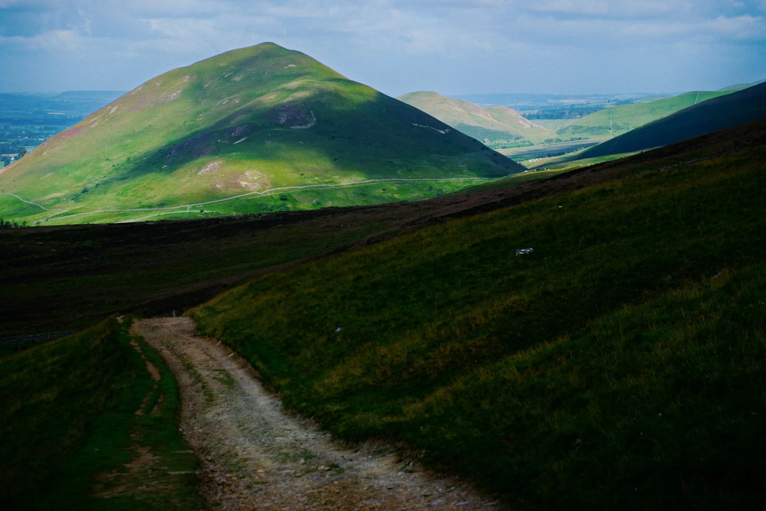  We&rsquo;re gaining height. A break in the clouds illuminates Dufton Pike and Knock Pike (398 m/1,305 ft) beyond. 