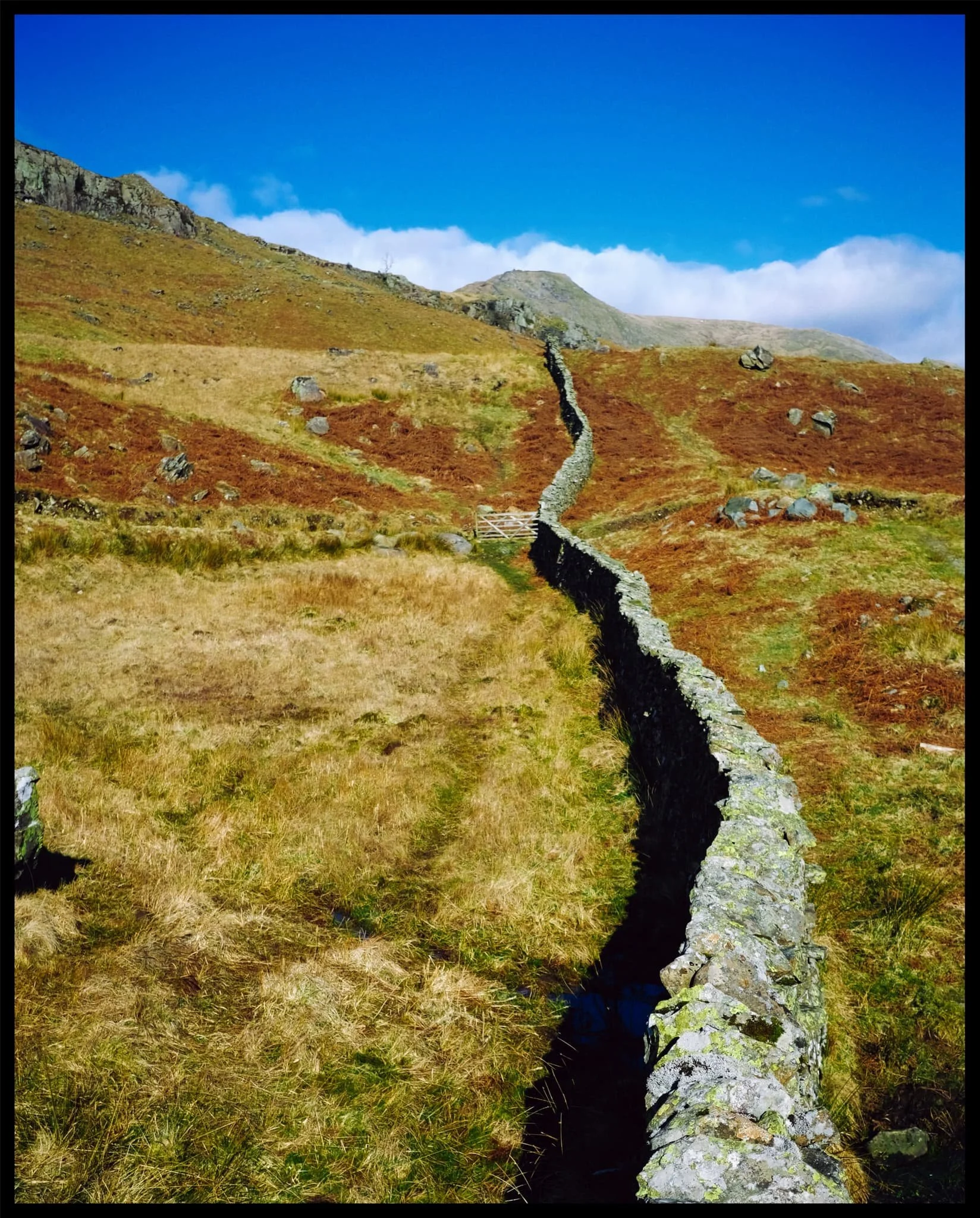  When crossing the stile, I paused at the summit of the climb to snap this obvious composition of the drystone wall leading all the way to High Pike. 