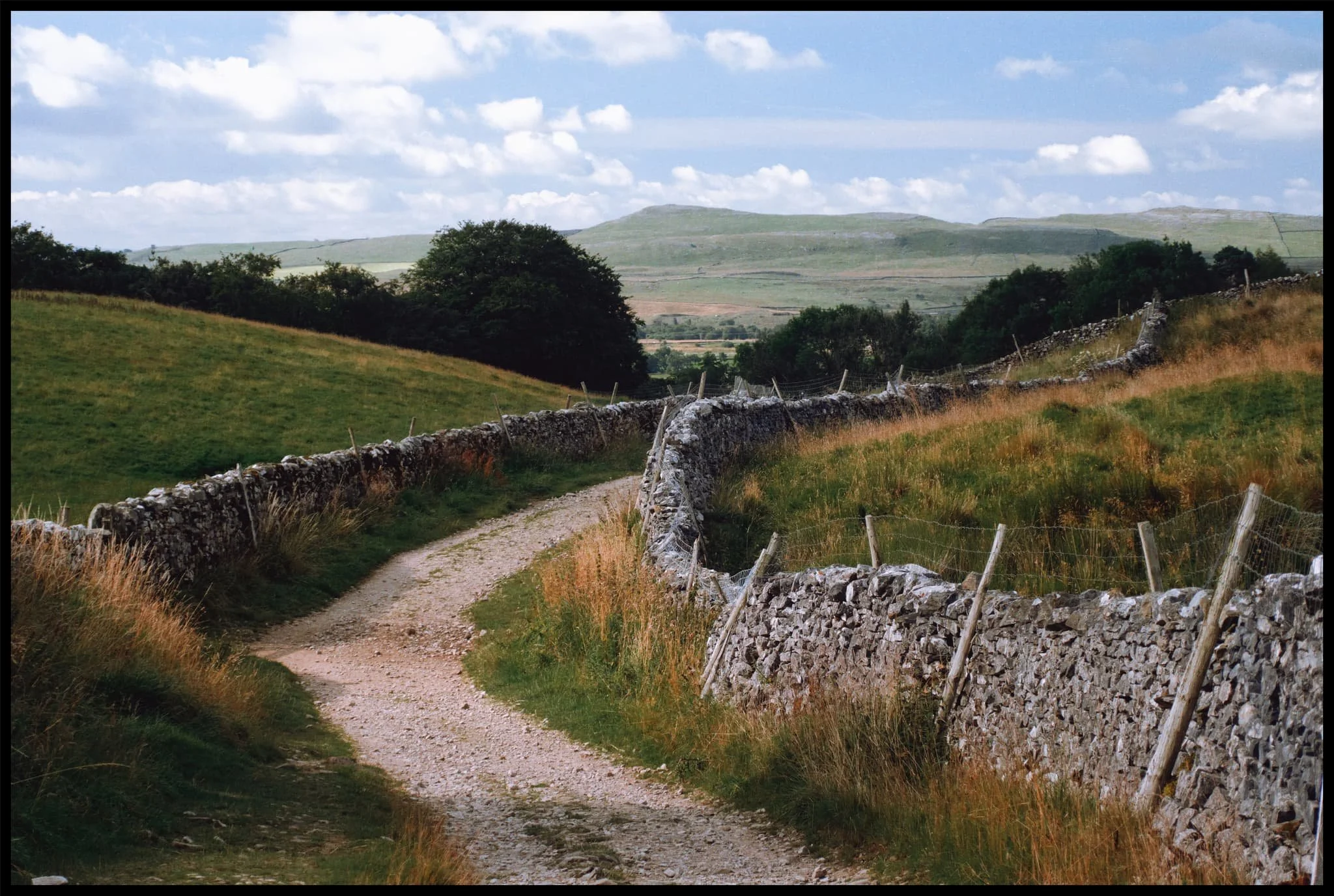  It&rsquo;s always important to check the view behind you occasionally. Beyond the winding drystone walls, Smearsett Scar rises above the karst landscape. 
