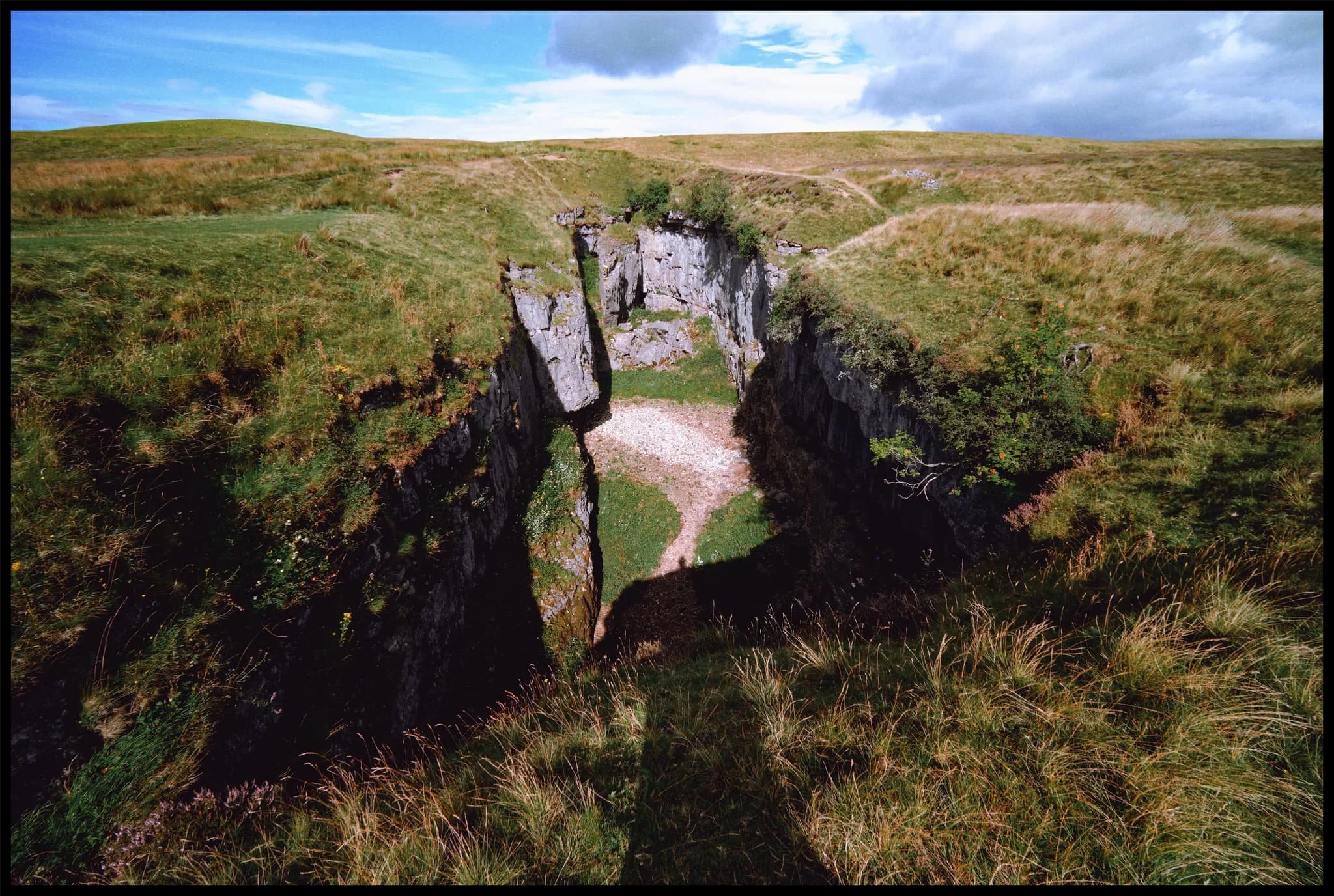  We arrive at Hull Pot. With my 9mm ultra-wide lens equipped, I shot this expansive view of the 60ft chasm from near its eastern edge. From the edge you can actually hear the rushing of a waterfall. 