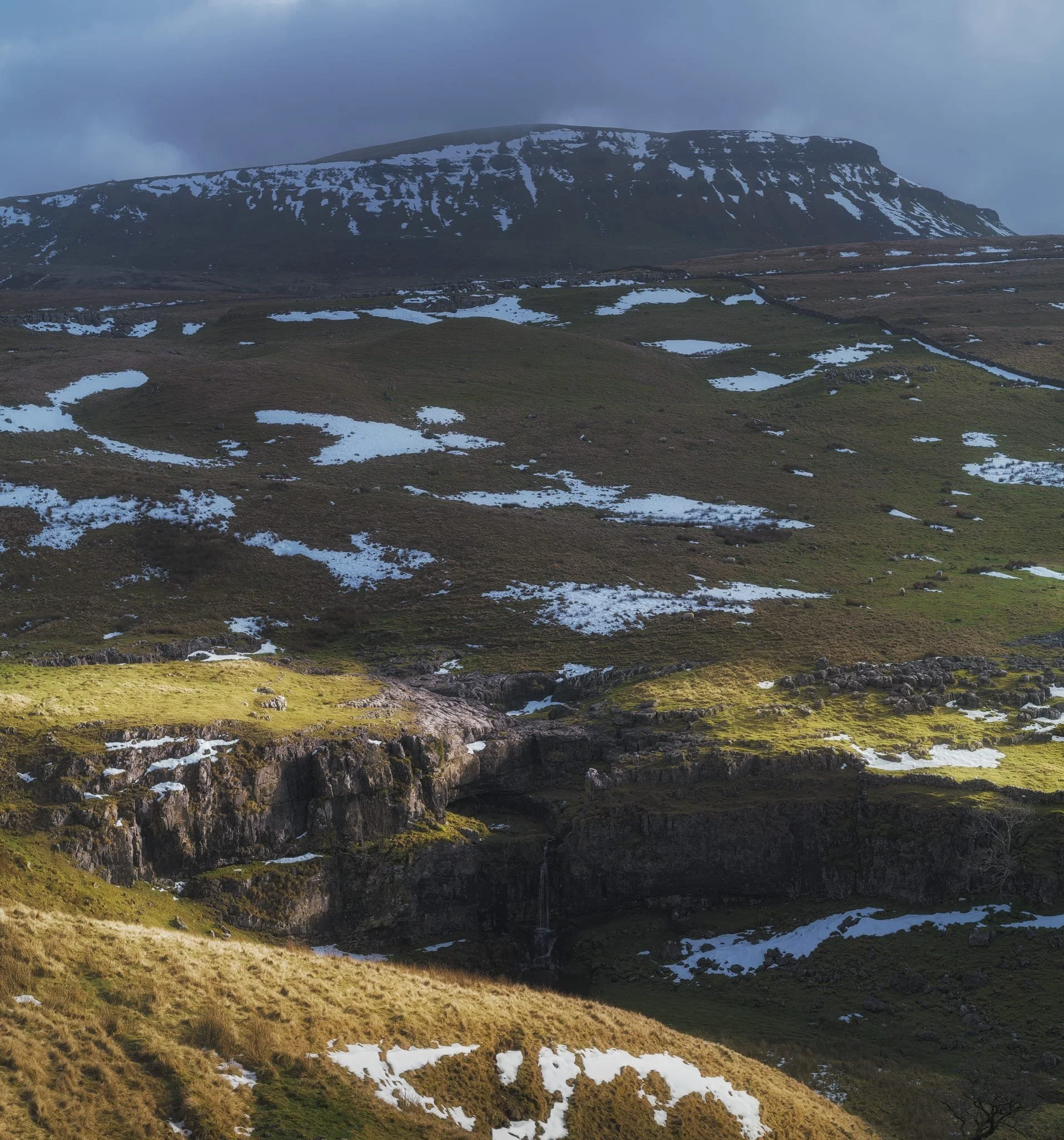  A good sign: A small waterfall where there usually isn&rsquo;t at Horton Scar. Above, Pen-y-Ghent fights with the dark and stormy clouds. 