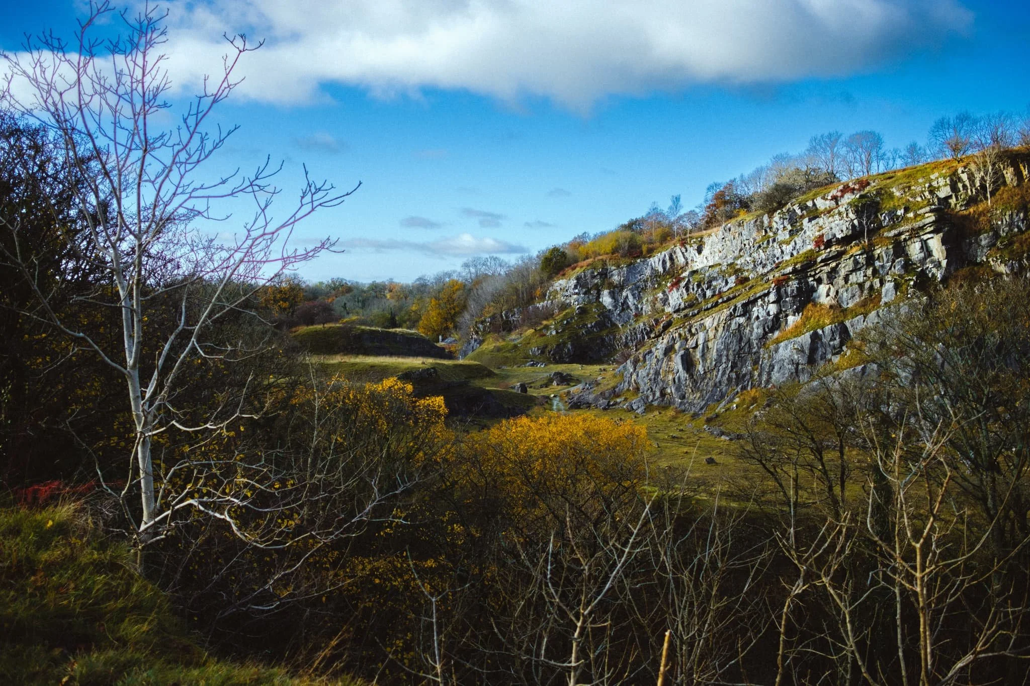  Before reaching the town of Ingleton the River Doe flattens out and the views open up. This is also the site of some in-progress limestone quarrying. I snap this final composition of the day as the sun illuminates the crag face of the quarry. 