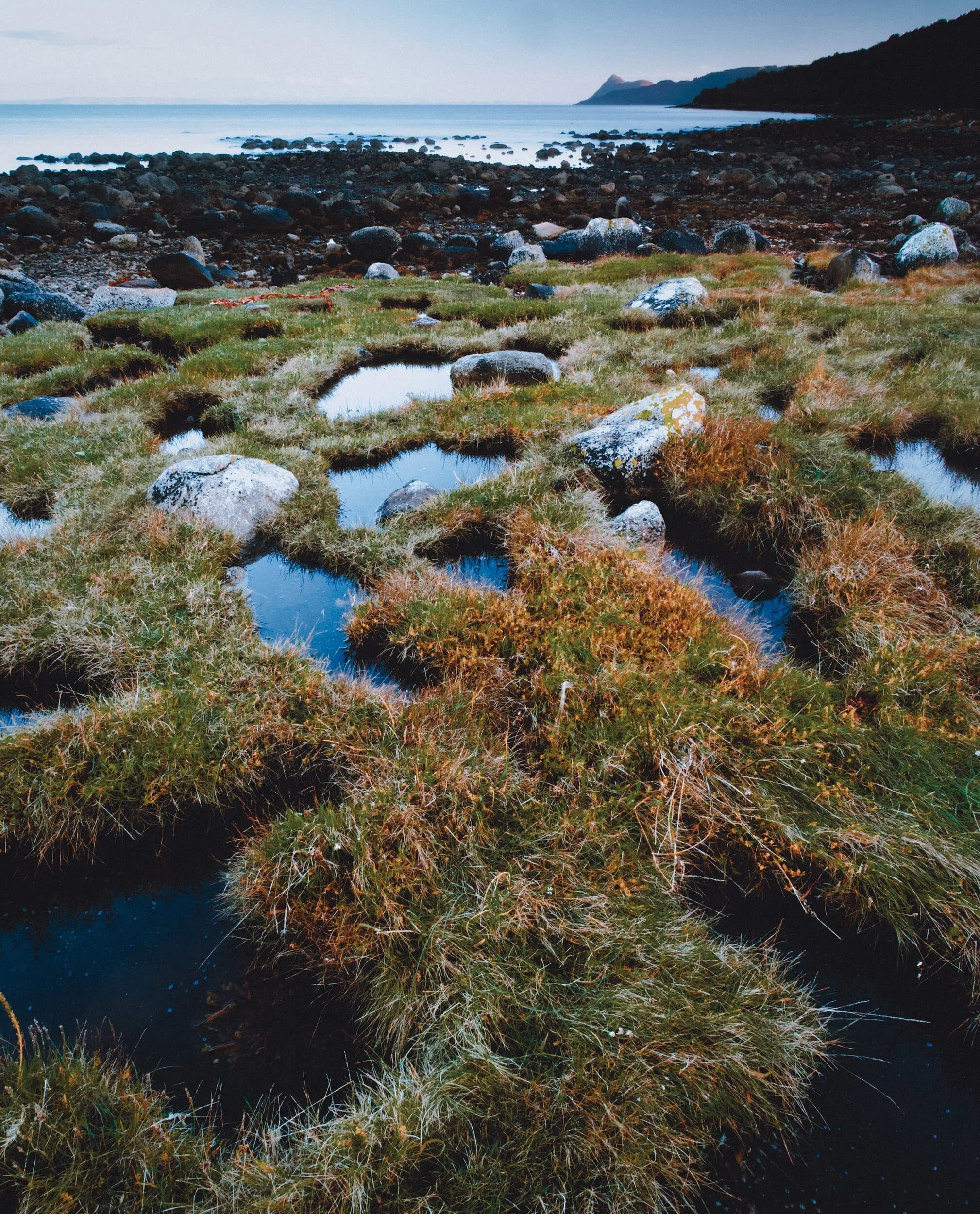  I loved the maze of patterns created by the grass and rock pools at Merkland Point. I framed this composition to fully fill up the frame with these patterns, set against Holy Island in the distance. We enjoyed a gentle sunset that evening, full of pastel pinks. 