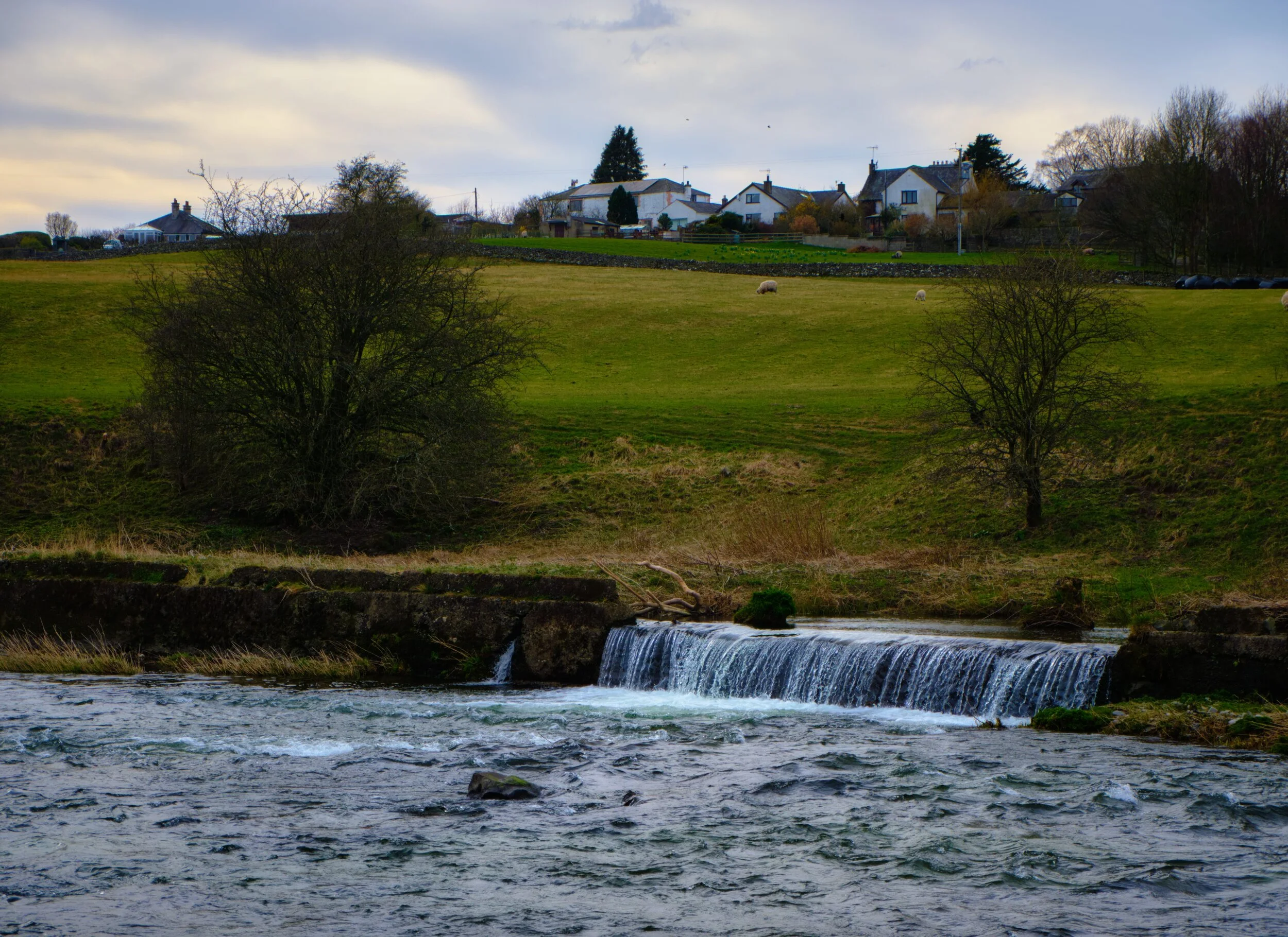  We found what we were guessing to be an old section of Kendal Canal, now extinct. Part of the wall that separated the canal from the river has succumbed to outside forces, and a cascade has formed. 