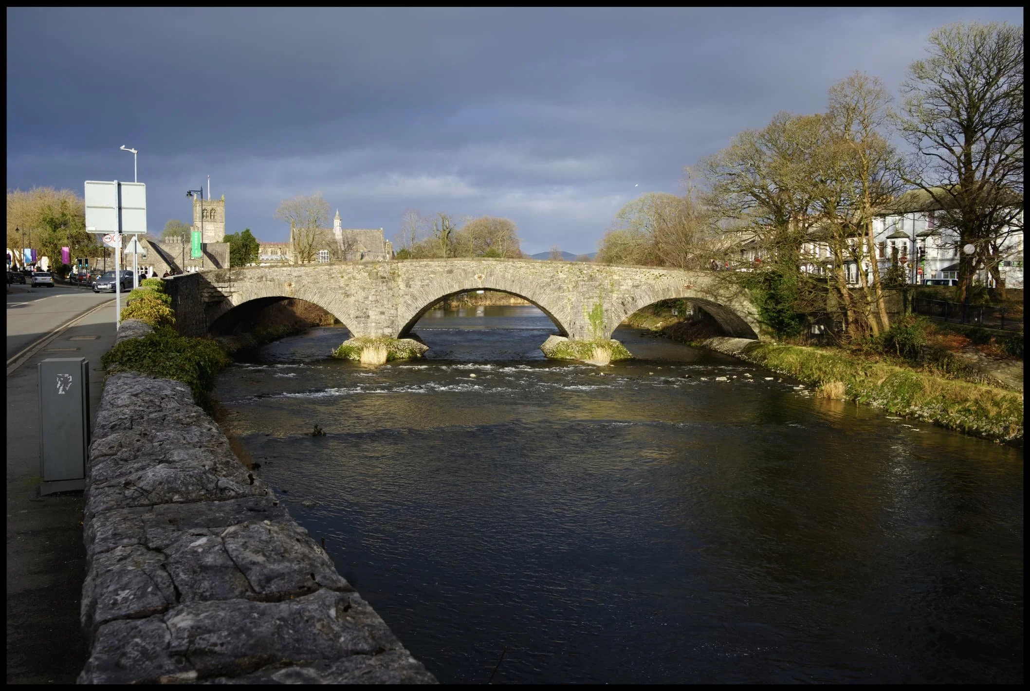  One of many old stone bridges in Kendal that cross the River Kent. This is Nether Bridge. It has records dating from the 14th century, and the 18th century packhorse bridge still exists underneath this newer 19th century construction. 