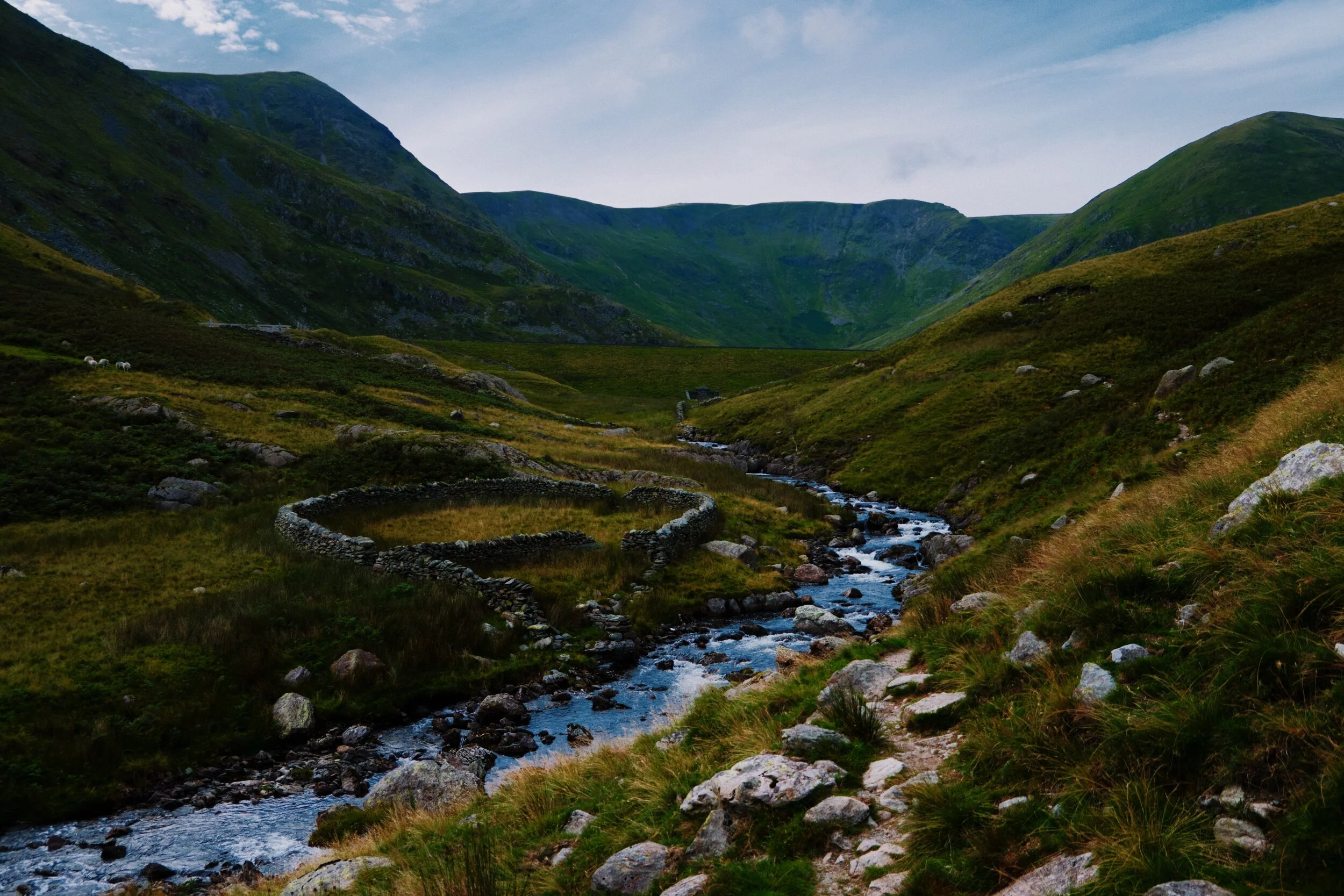  A wet and undulating path at Whether Fold to navigate now as we near the reservoir. The peak on the left is Froswick, the &ldquo;wall&rdquo; in the middle is Gavel Crag (the southern face, ultimately, of High Street), and the rightmost peak is Lingmell End. 