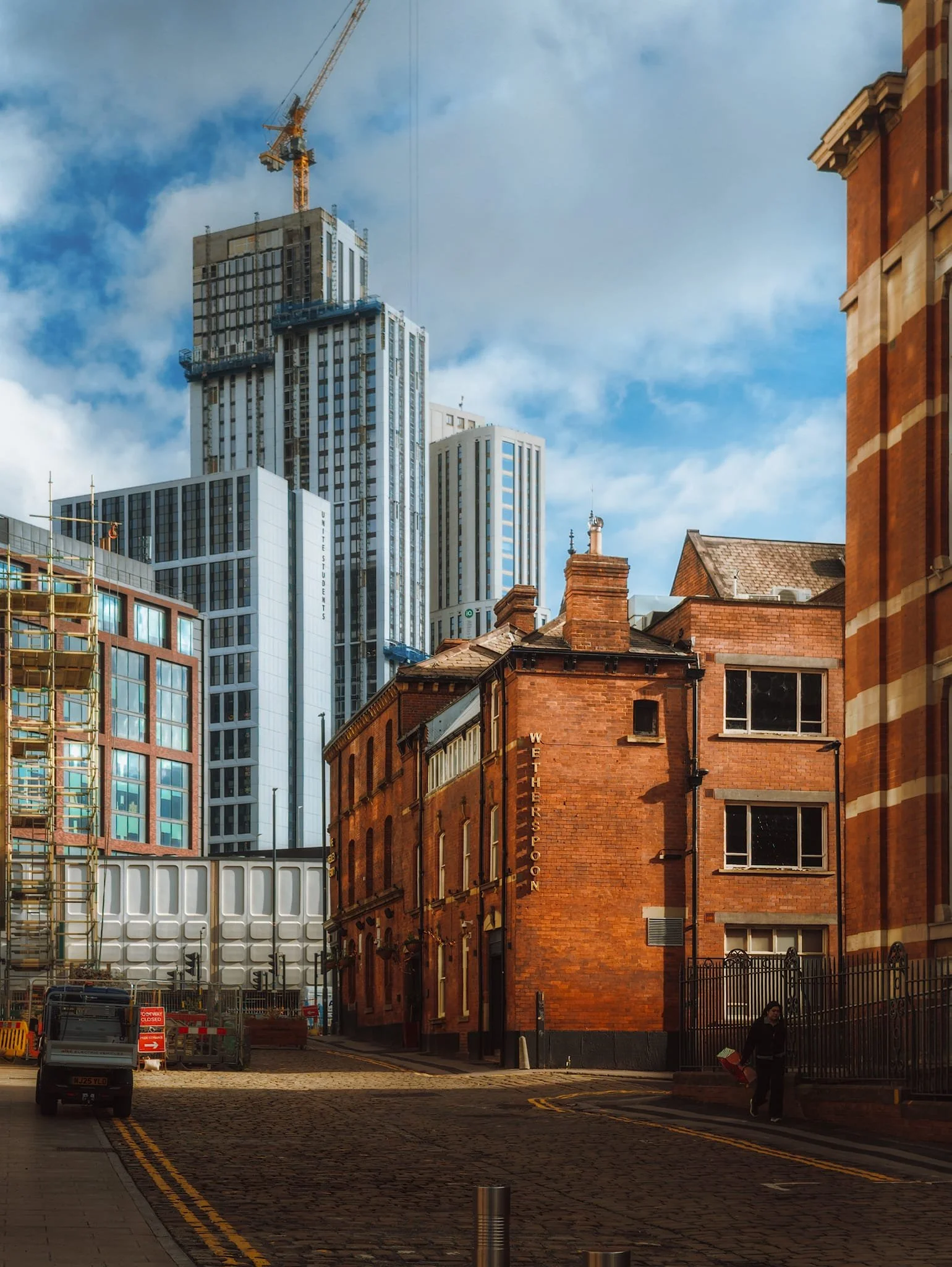 I enjoyed composing juxtapositions between old Leeds and new Leeds, such as this view down Vernon Street towards the old red-brick building pub,  The Hedley Verity , with the to-be-completed  United Students  skyscraper. 