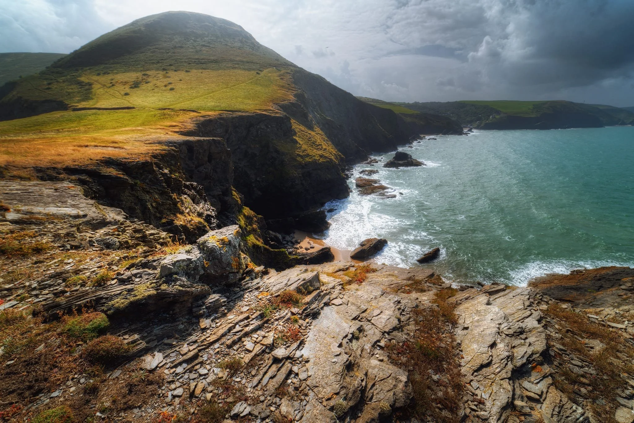  Down onto the peninsula, the cliff edge views were simply awe-inspiring. My first composition here is looking back to  Pendinaslochdyn  hill, where you can see that part of the hill&rsquo;s shoulder has now fallen away into the sea. That is also where the trail is. Yikes. 