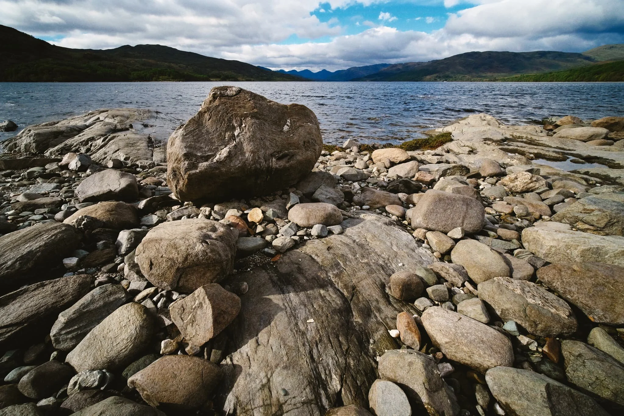  Another sculpted boulder provides an interest foreground subject as contrast against the dark mountains in the distance, 