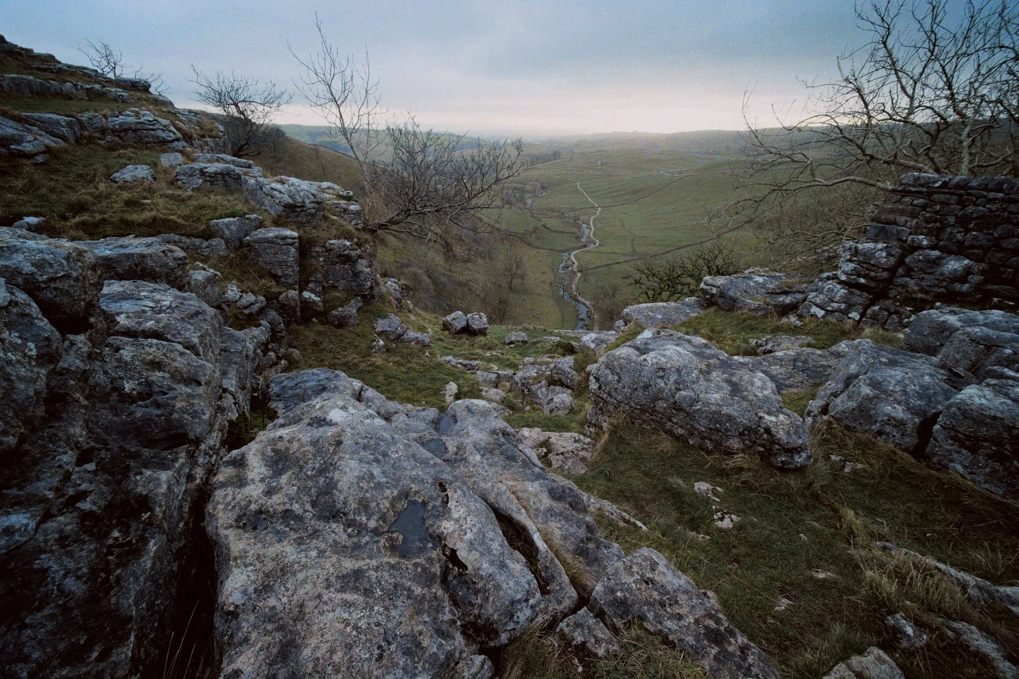  At various points, sudden gaps along the cliff edge opened up, offering views down to Malhamdale. These would&rsquo;ve been smaller waterfalls that tumbled down Malham Cove, aside from the main one. 