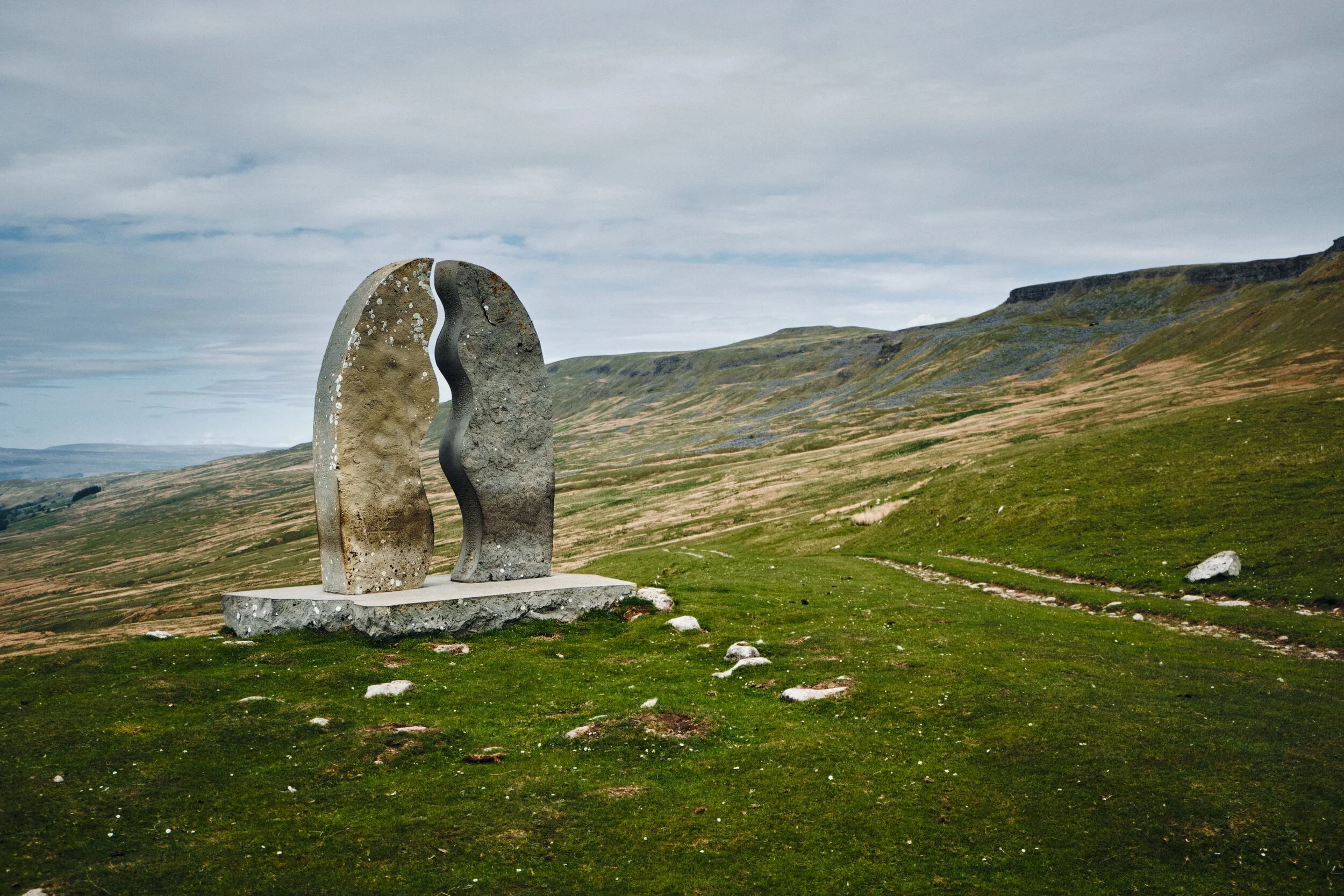  This sculpture, found on the Pennine Bridleway, is called  &ldquo;Watercut&rdquo; by Mary Bourne . The watery gap that divides the sculpture utilises the changing sky to echo the ever-changing flow of water. To the right is the flat-topped Mallerstang Edge. 
