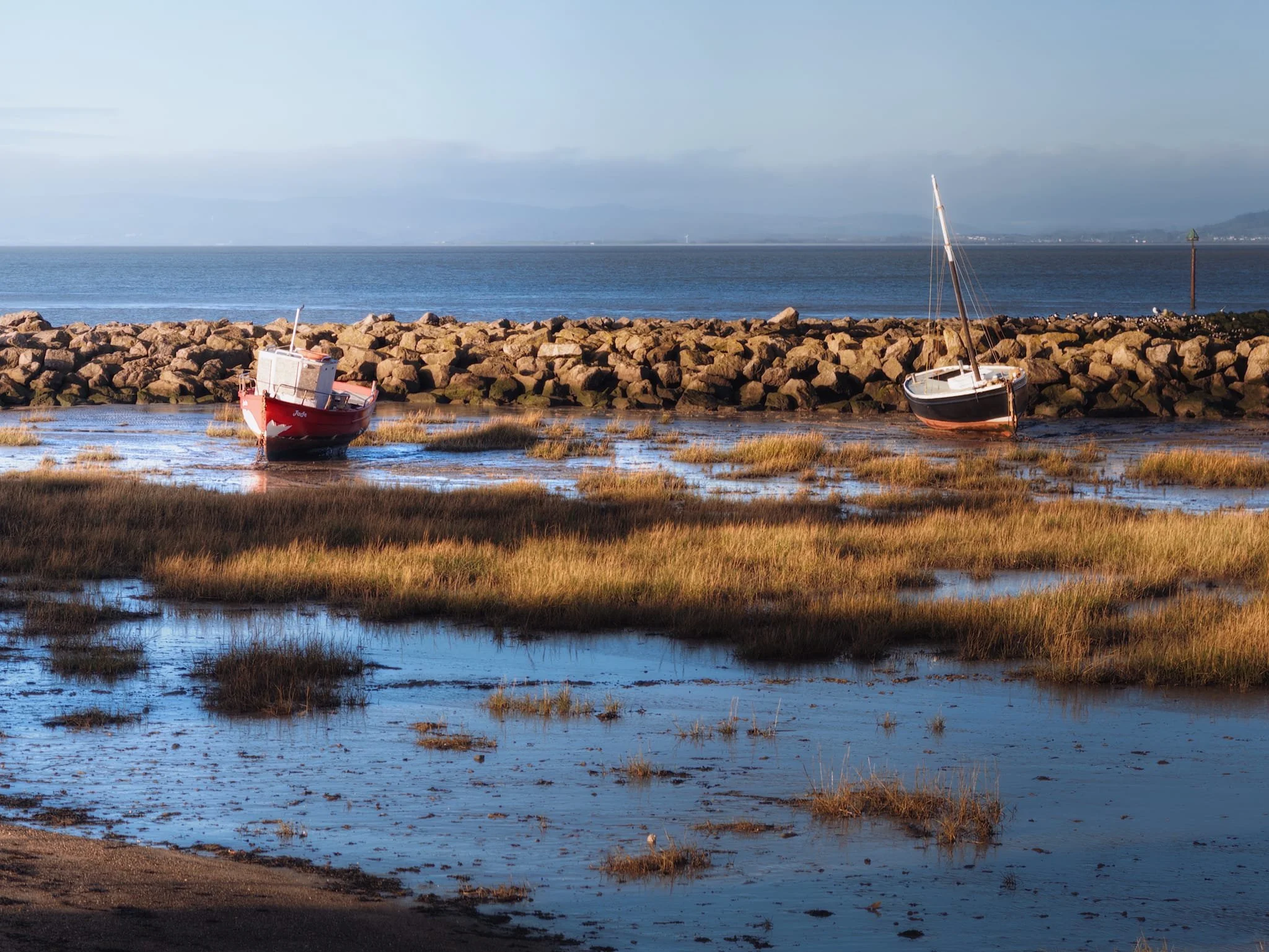  The tide at Morecambe Bay moves  fast . Moored boats were already emerging from their watery parking area. 