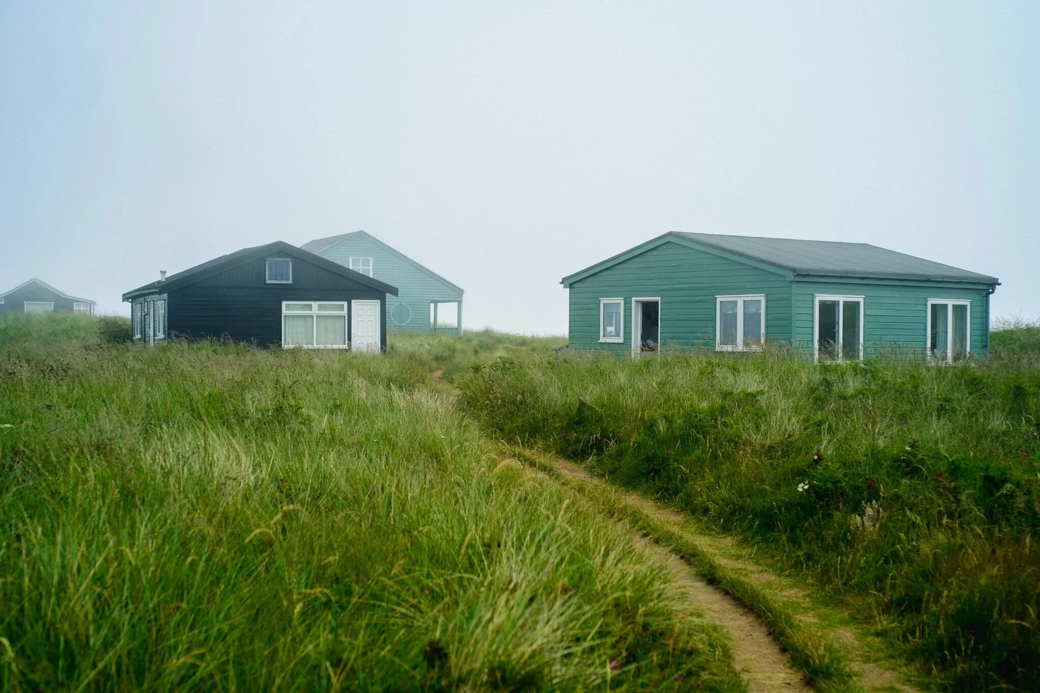  Above Embleton Bay, near the Embleton Links golf course, there&rsquo;s a whole bunch of &ldquo;beach chalets&rdquo; or, more accurately, bungalows that sit on National Trust land. On a clear sunny day I&rsquo;ve no doubt they look adorable and inviting. With the sea fret rolled in, the bungalows presented a more foreboding presence. 