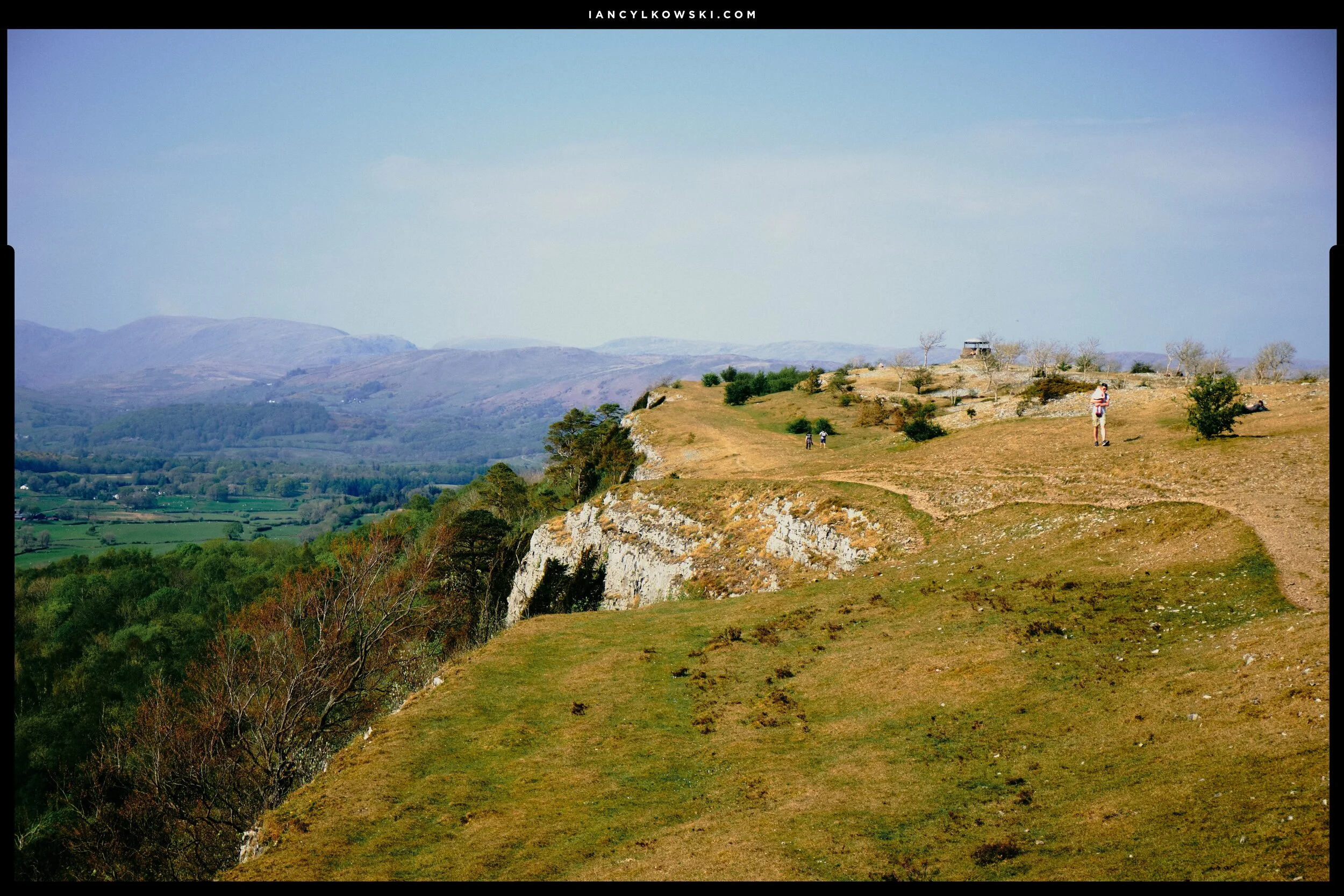  One or two walkers enjoy their Government Permitted Outdoor Exercise. In the distance, on the right, you can just make out The Mushroom, a shelter that sits at the summit of Scout Scar. 