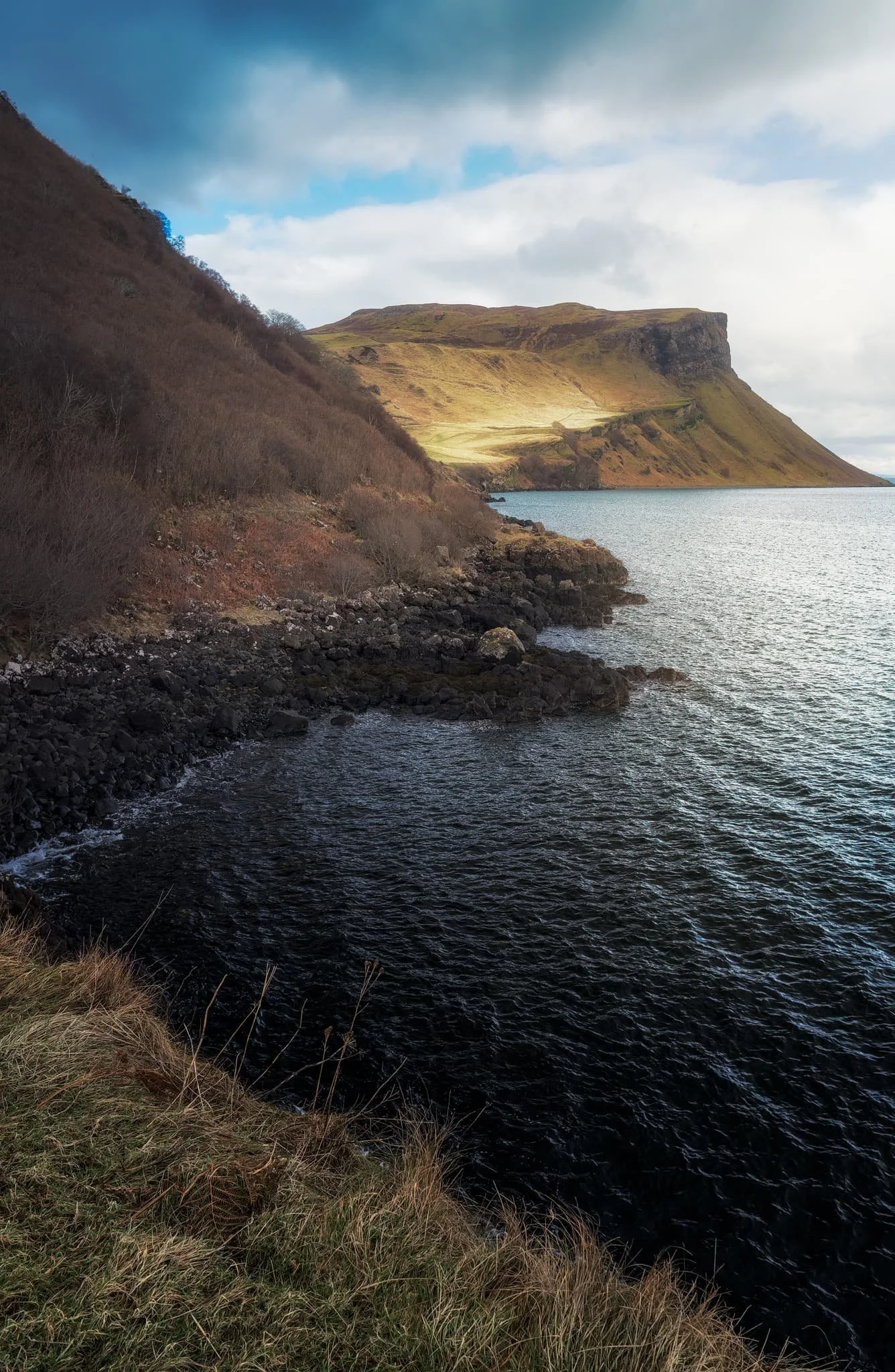  As we rounded the corner at Sgeir Mhòr, this magnificent view down the coastline to the illuminated cliffs of  Sìthean a&rsquo; Bhealaich Chumhaing  appeared. 