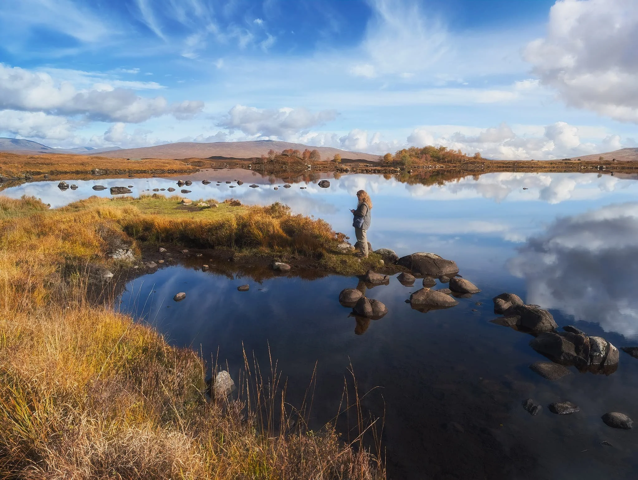  Looking northeast across the loch, I line up this composition with the loch&rsquo;s glassy reflections, the distant hills, and my Lisabet ensuring she&rsquo;s captured what she wanted. 