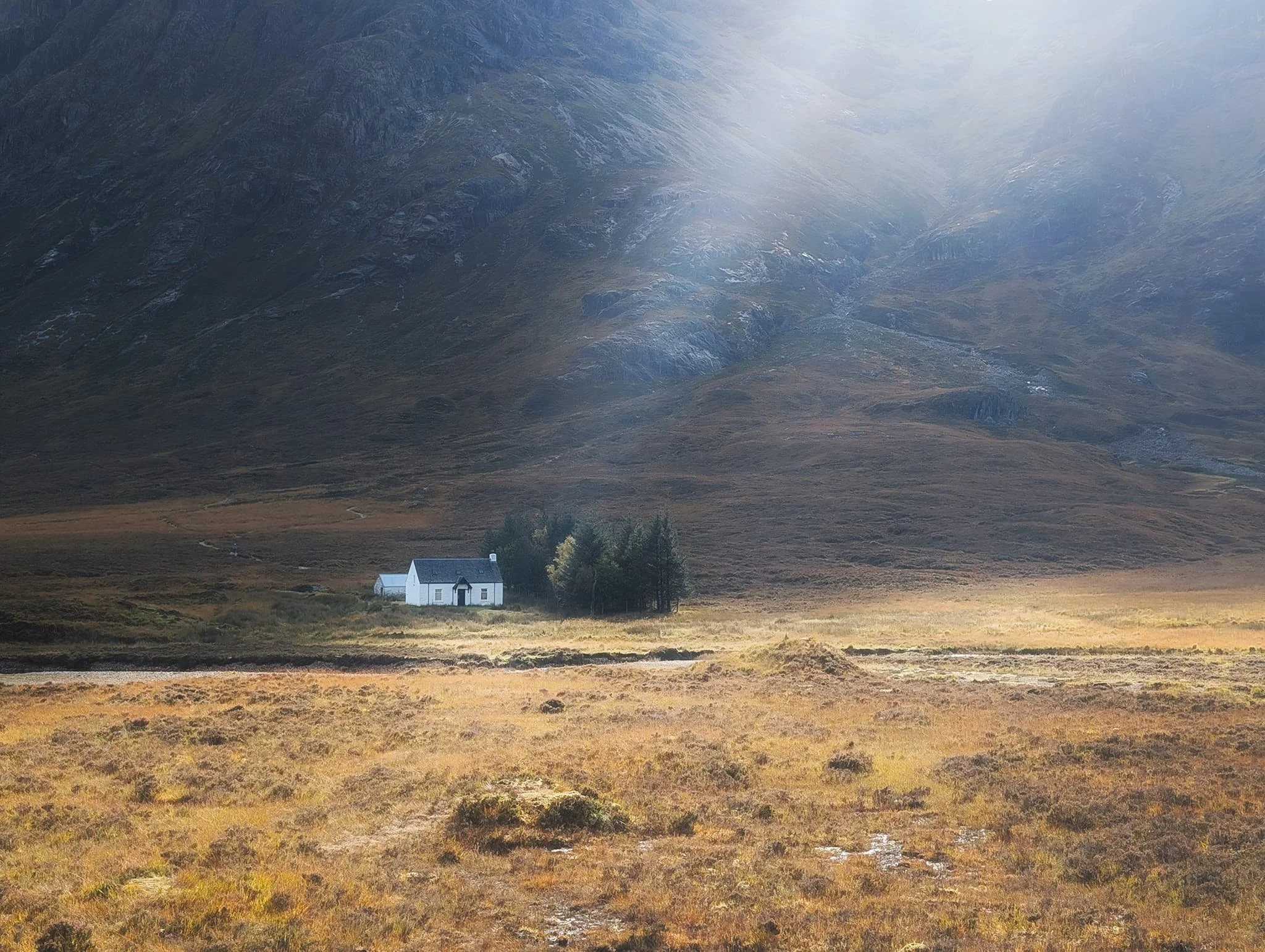  As we moved further into Glencoe, we stopped at an area we&rsquo;ve often just driven by, at Altnafeadh. Here, underneath the massive wall of rock that is  Stob Dearg , is a delightful little white cottage, all on its own. This is Lagangarbh Hut. Formerly a crofting house, it was bought by the National Trust for Scotland in 1935, and the Scottish Mountaineering Club have been looking after it since 1946. 