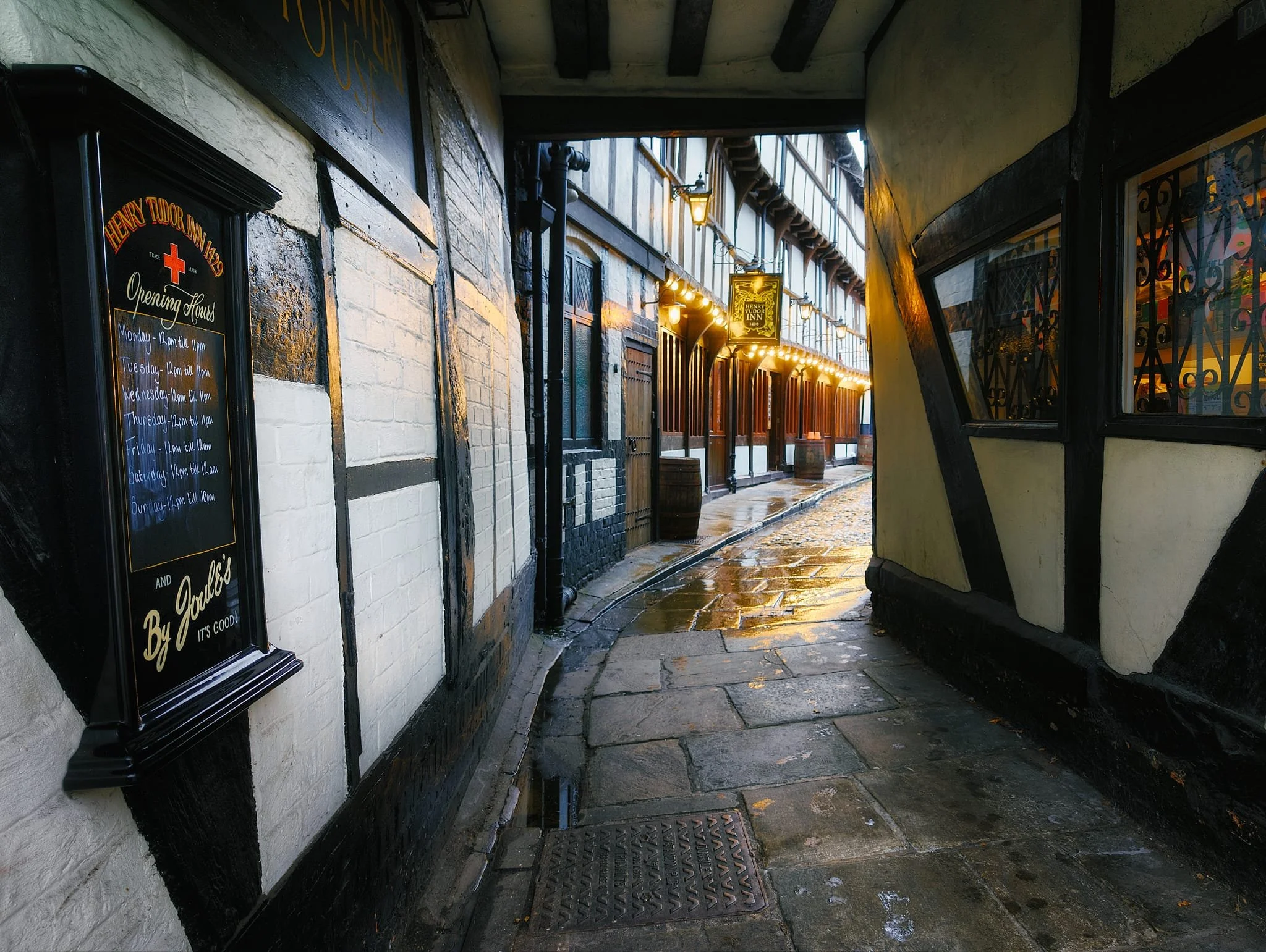  Built in the mid-1400s, the  Henry Tudor Inn  is an outstanding example of a late-medieval inn that retains super rare original features. A plaque records that Henry VII lodged here in 1485 before Bosworth. Originally a first-floor hall built over shops, with a rear wing connecting to the Trotting Horse building on Barracks Passage. As the light darkened blue, the lights of the inn flickered on and I nabbed this beautiful composition. 
