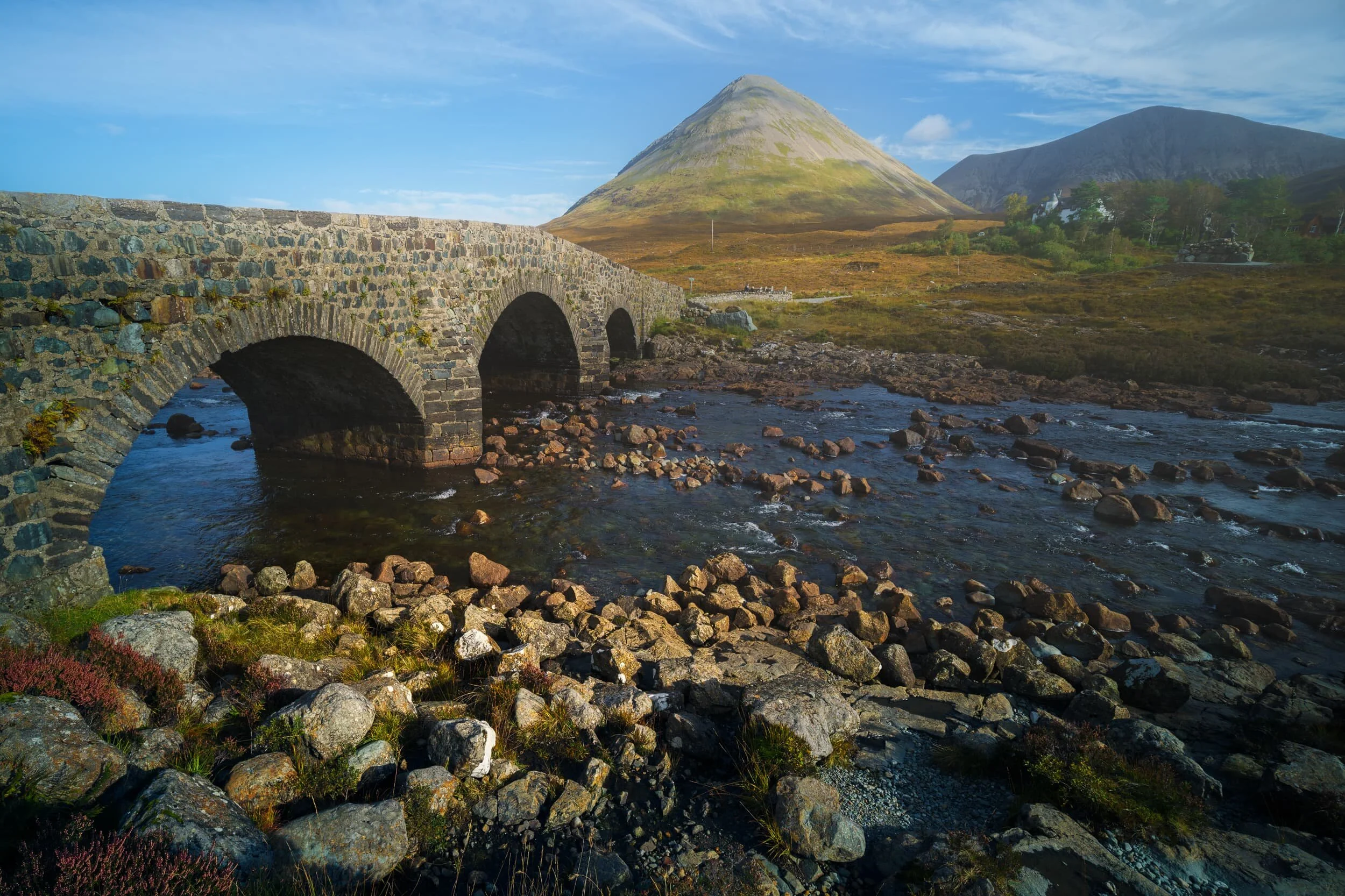  I&rsquo;ve talked about, and photographed, the Black Cuillins a lot on Skye, but there is another mountain range located next door to them. They are the Red Cuillins. Whereas the Black Cuillins are jagged and craggy, owing to them primarily being composed of coarse and hard volcanic gabbro rock, the Red Cuillins a made of granite, resulting in smaller and smoother hills. Here I utilised the Old Sligachan Bridge has a leading line towards  Glamaig  (775 m/2,543 ft). 
