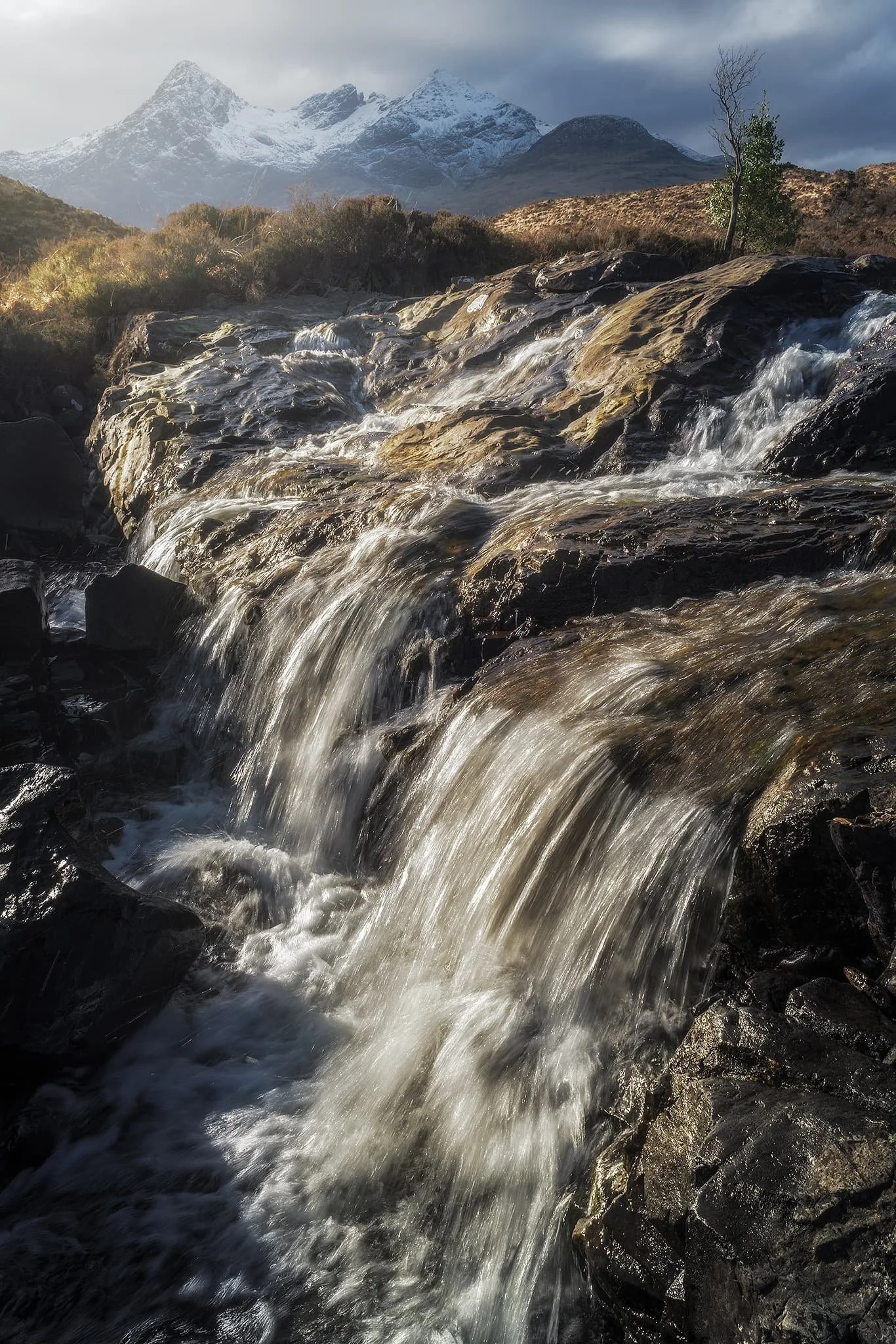  Beyond the large waterfall, a wide series of falls presented a beautiful composition involving the Black Cuillins as the clouds sank over the mountains.  