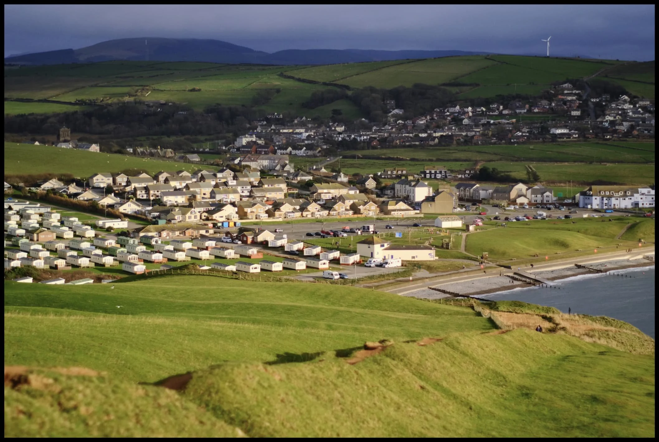  St. Bees getting drenched in golden wintersun with the dark Muncaster Fells behind. 