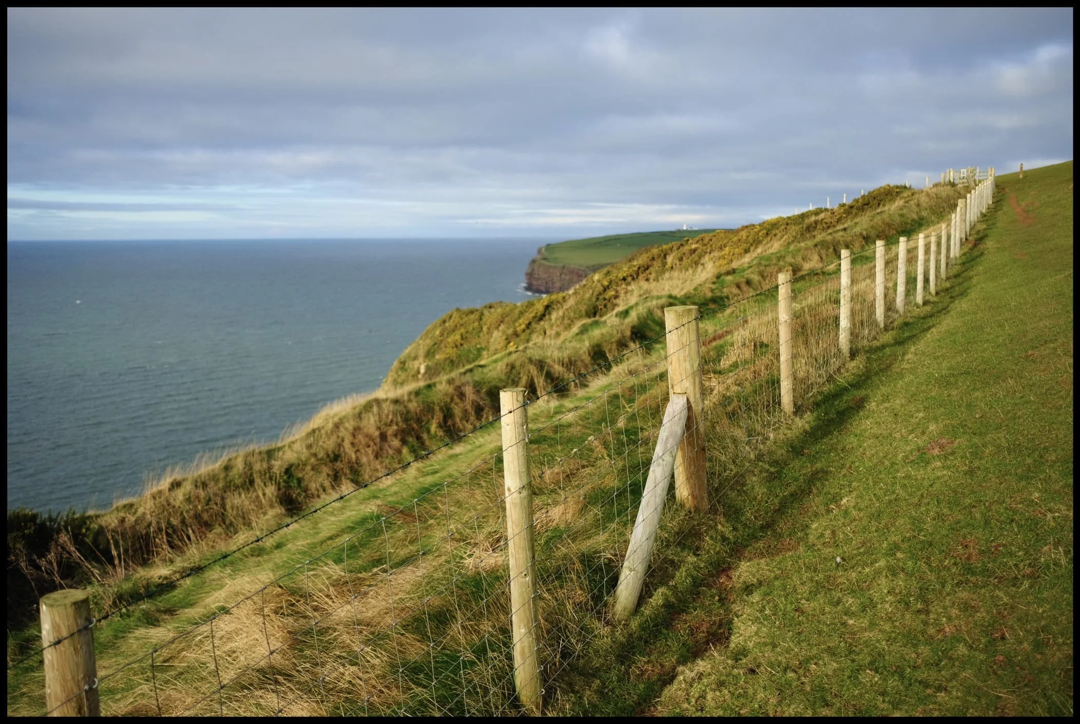  To be safe, we stayed on the inland side of the path. The cliffs surrounding Fleswick Bay become more visible. 