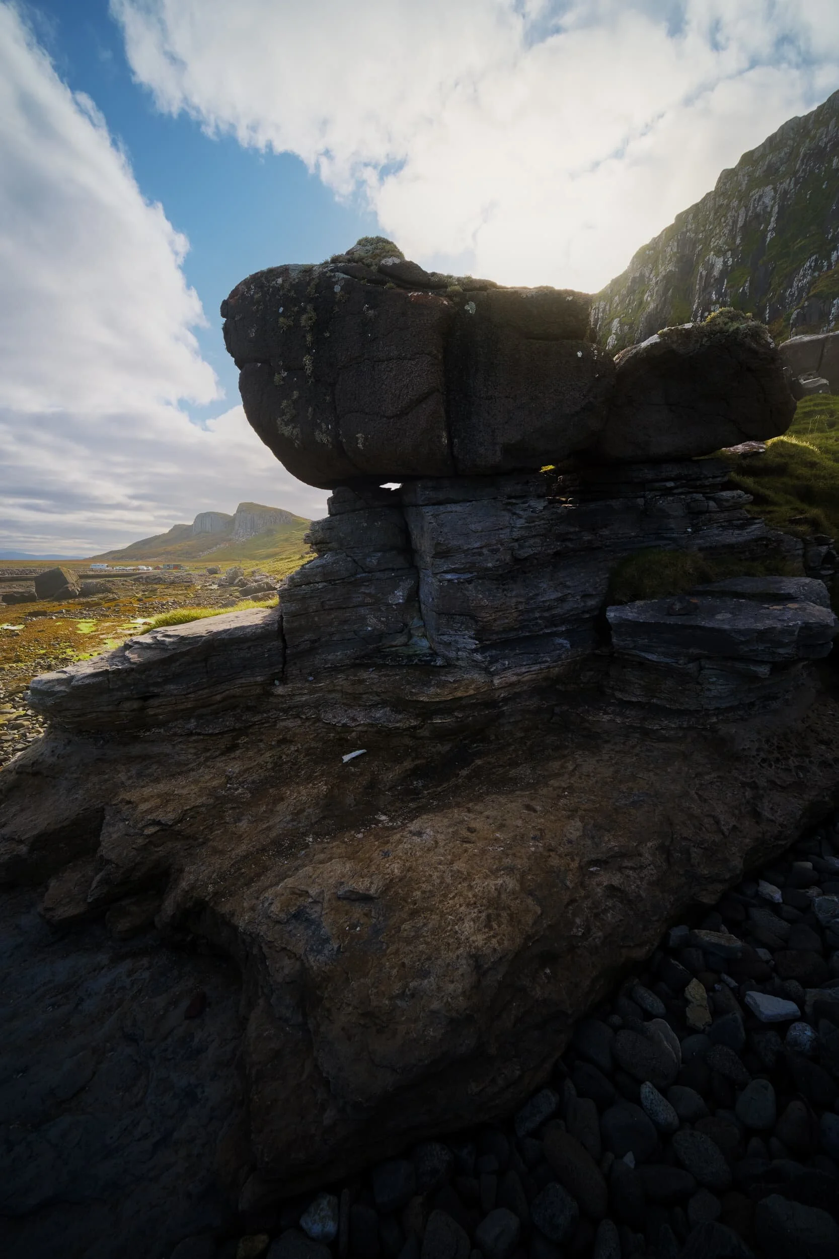  More glacial erratics perched on sculpted formations. In the distance, to the left, are the two cliff faces of  Sgeir Bhàn . 