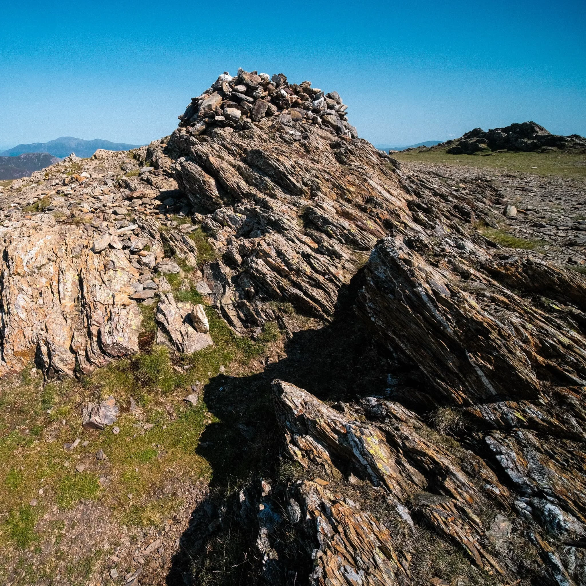  Fascinating geology.  This is apparently an &ldquo;olistostrome of disrupted, sheared and folded mudstone, siltstone and sandstone&rdquo;. I also liked in this composition our the pile of rocks on the right mirrored the shape of the Skiddaw range to the left. 