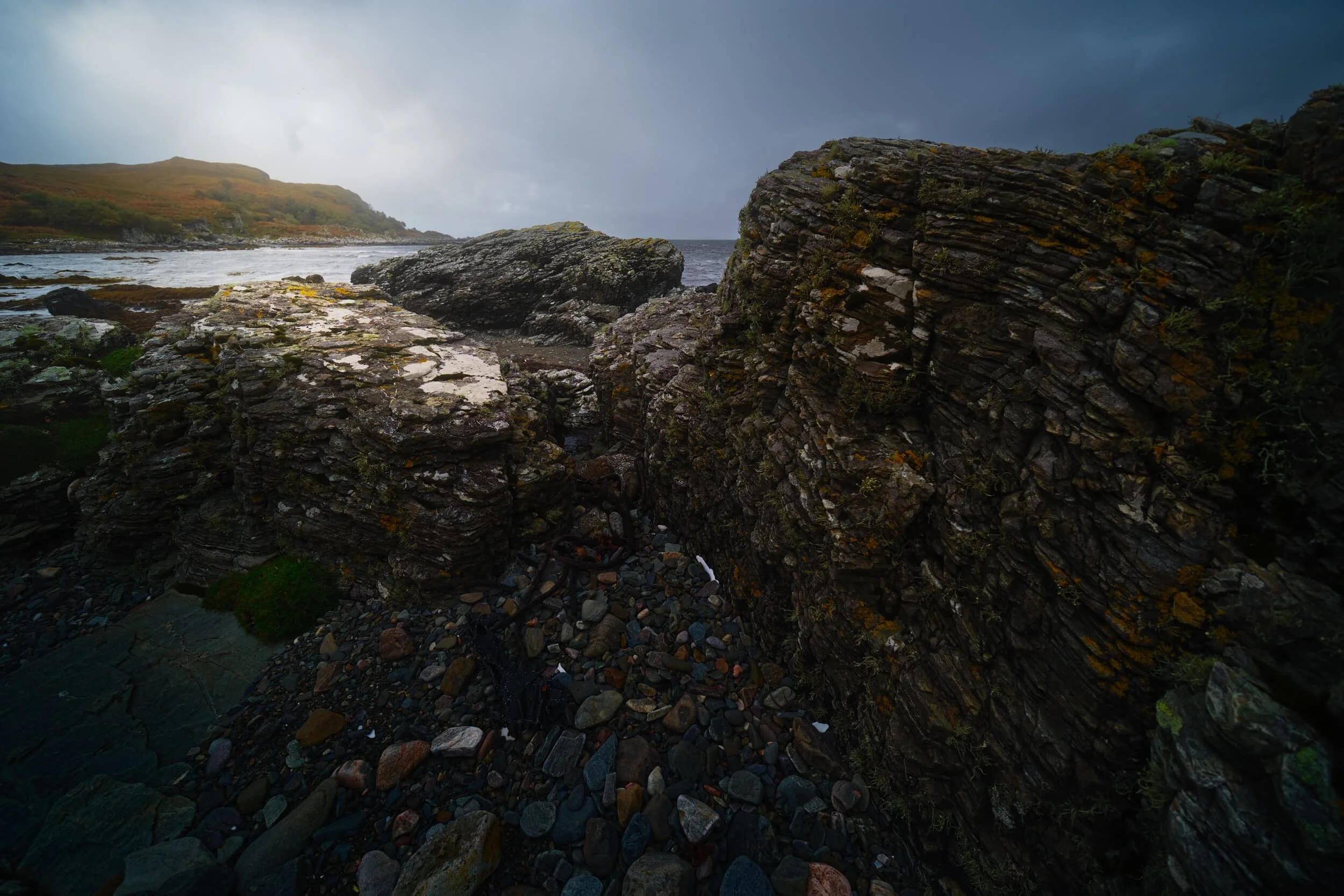  My eye quickly round some rather interesting rock formations around Gillean beach. I endeavoured to make some compositions whilst it was vaguely dry enough to shoot. The hill on the left is  Sìthean Beag . 