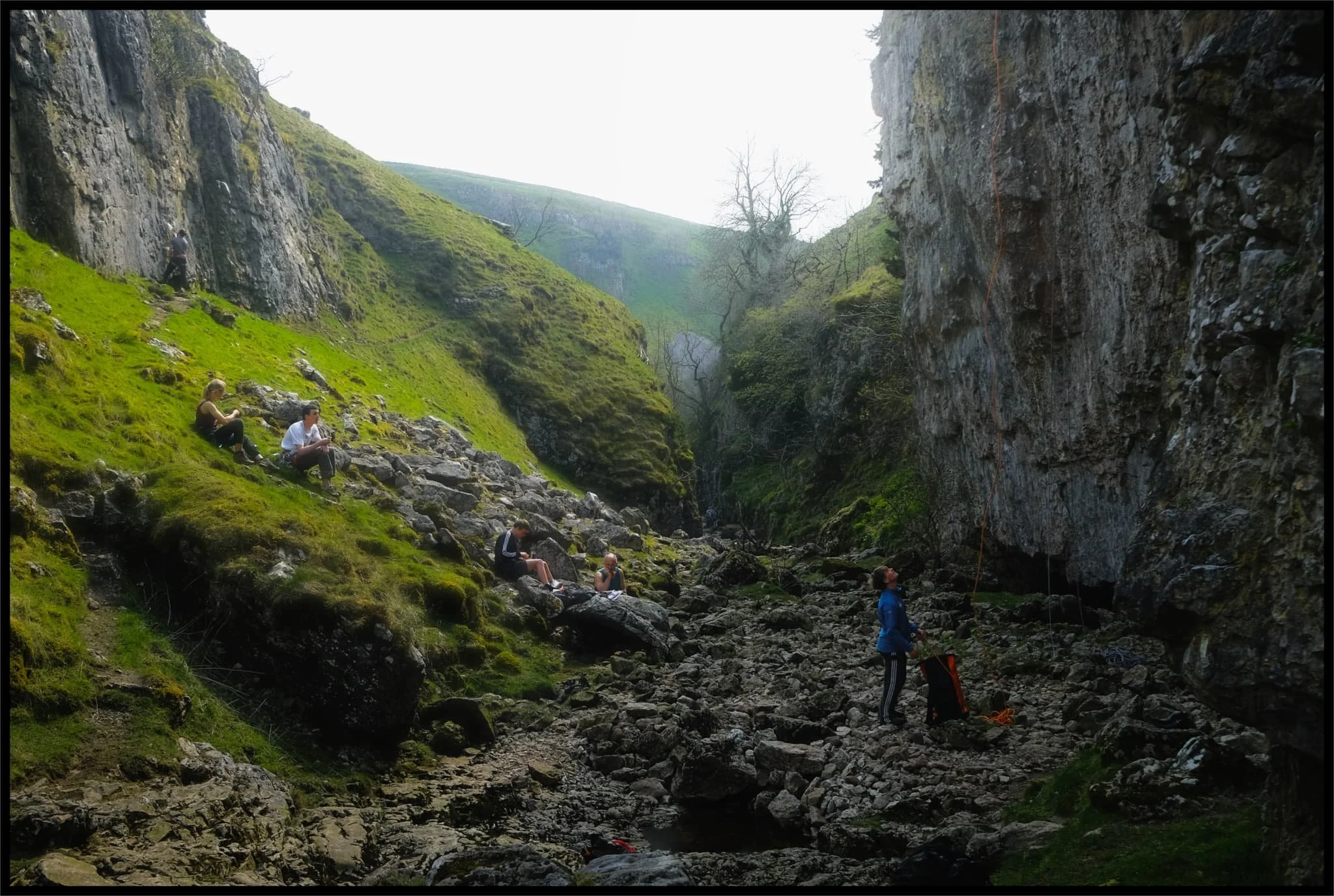  Rock climbers assist each other as they ascertain routes up the sheer sides of Trollers Gill. 