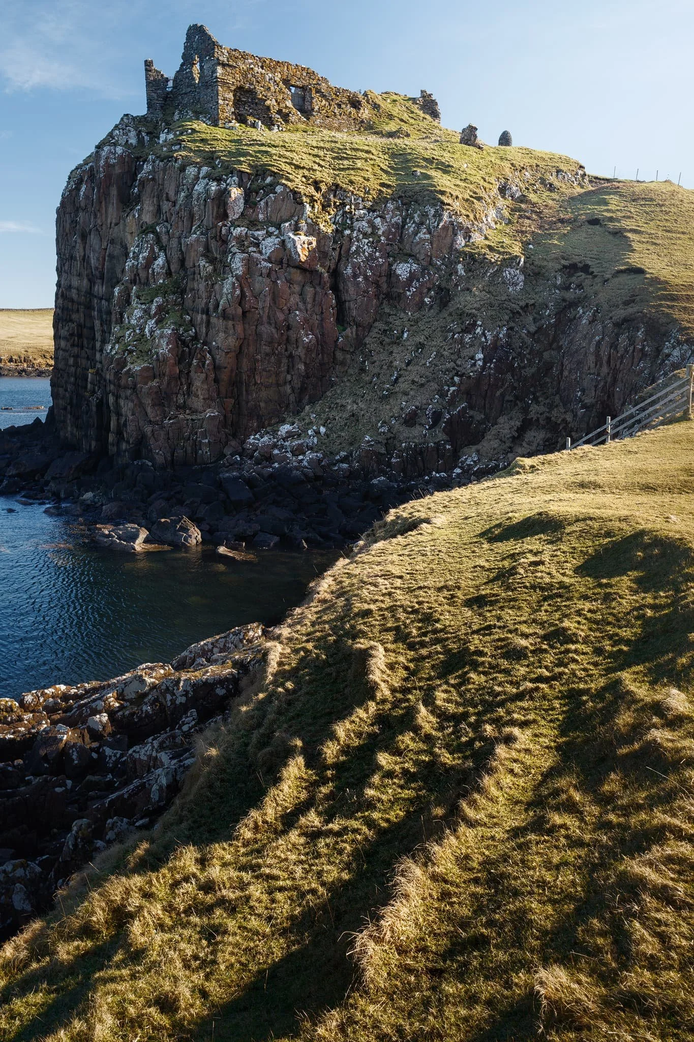  Closer to the castle ruins, the sun broke out from the clouds above the Quiraing, giving fantastic side light to this scene. These ridged tufts of grass made for a nice compositional leading line into the scene.  