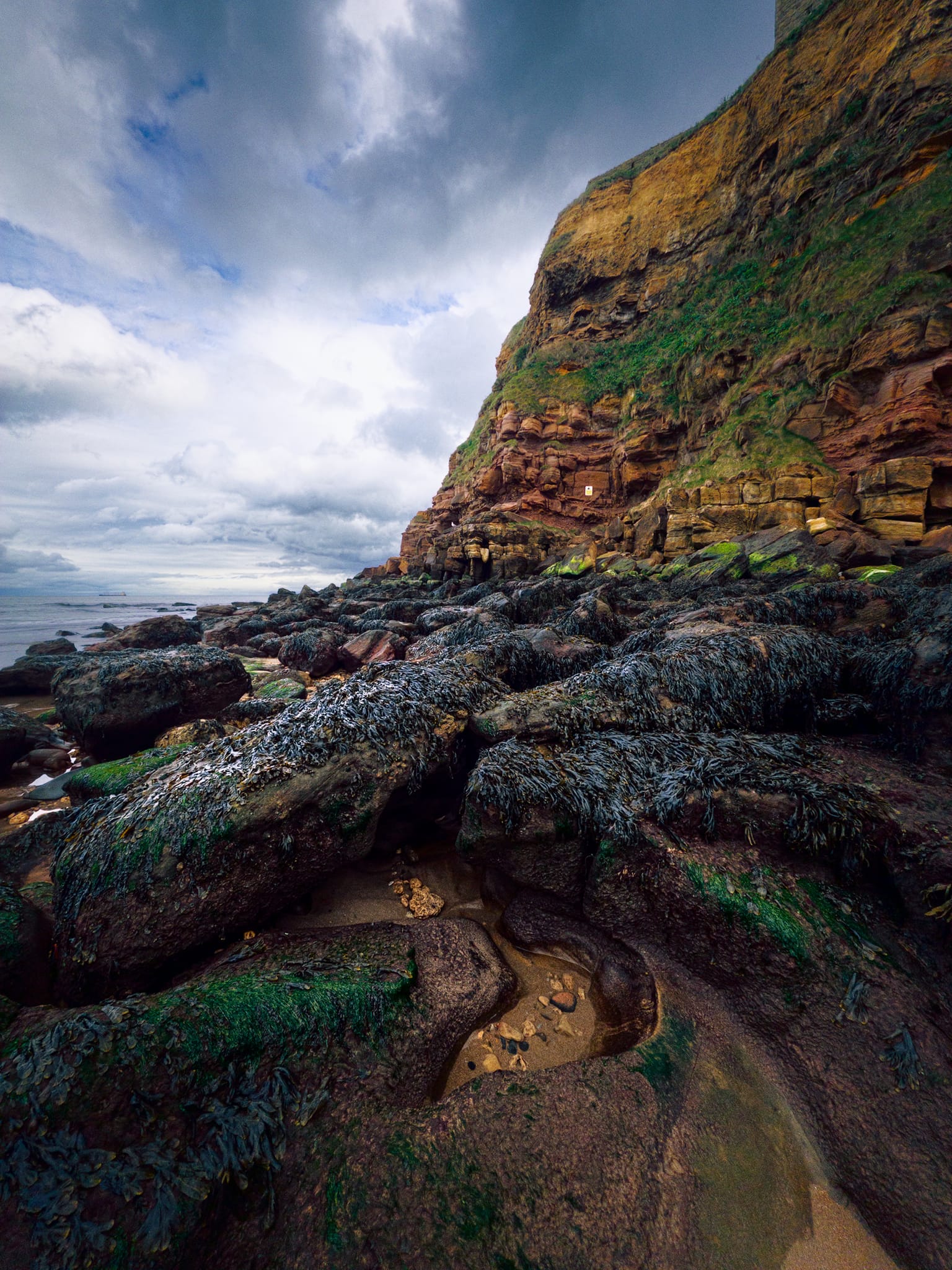 The clouds raced overhead as Storm Dave made its presence known. Beautifully sculpted boulders beneath the cliffs made for a pleasing arrangement of elements.