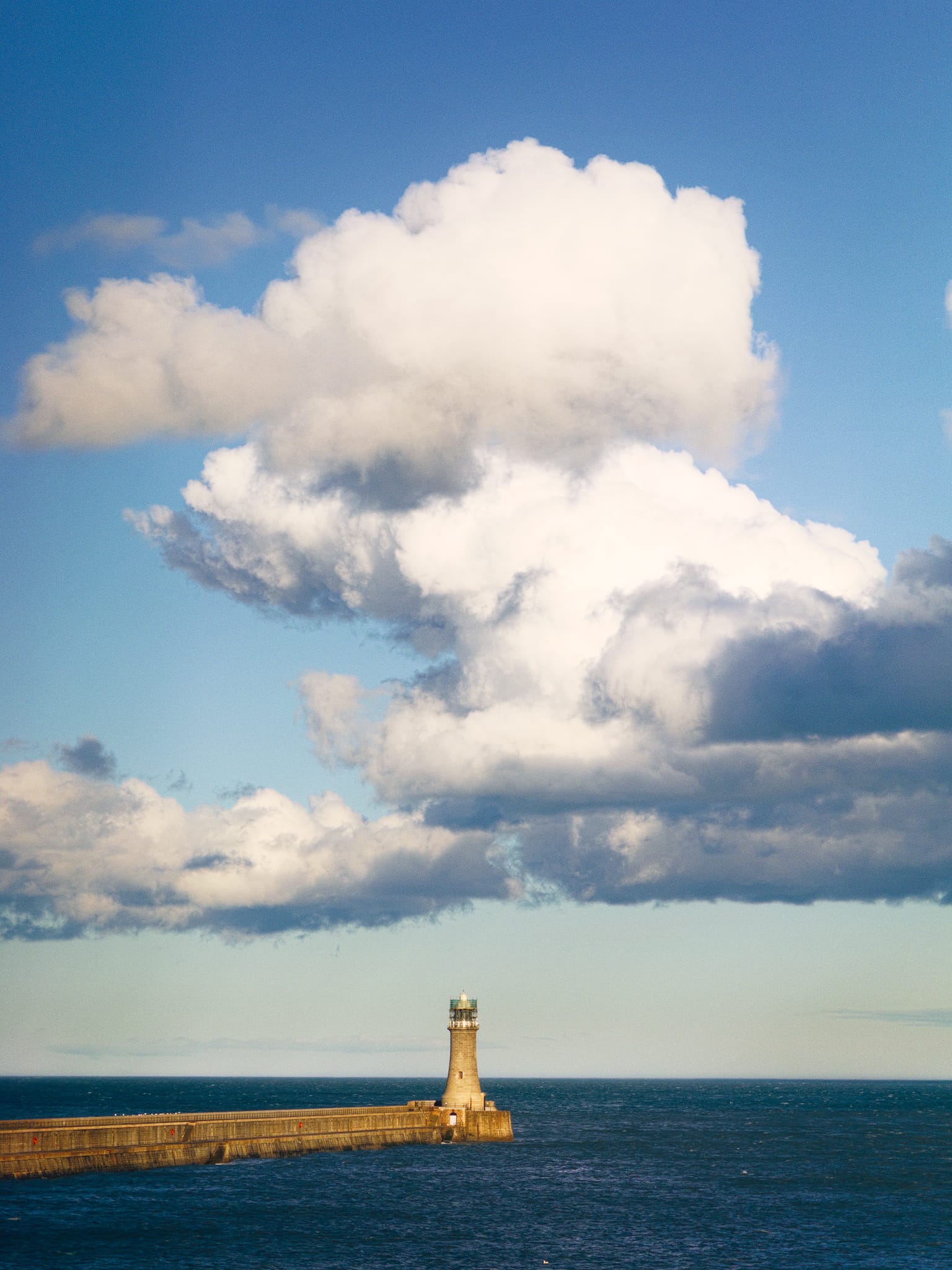 As the worst of Storm Dave cleared, we returned to Tynemouth proper later in the evening. This is Tynemouth’s North Pier, which I zoomed into to isolate the lighthouse against the warm clouds above.