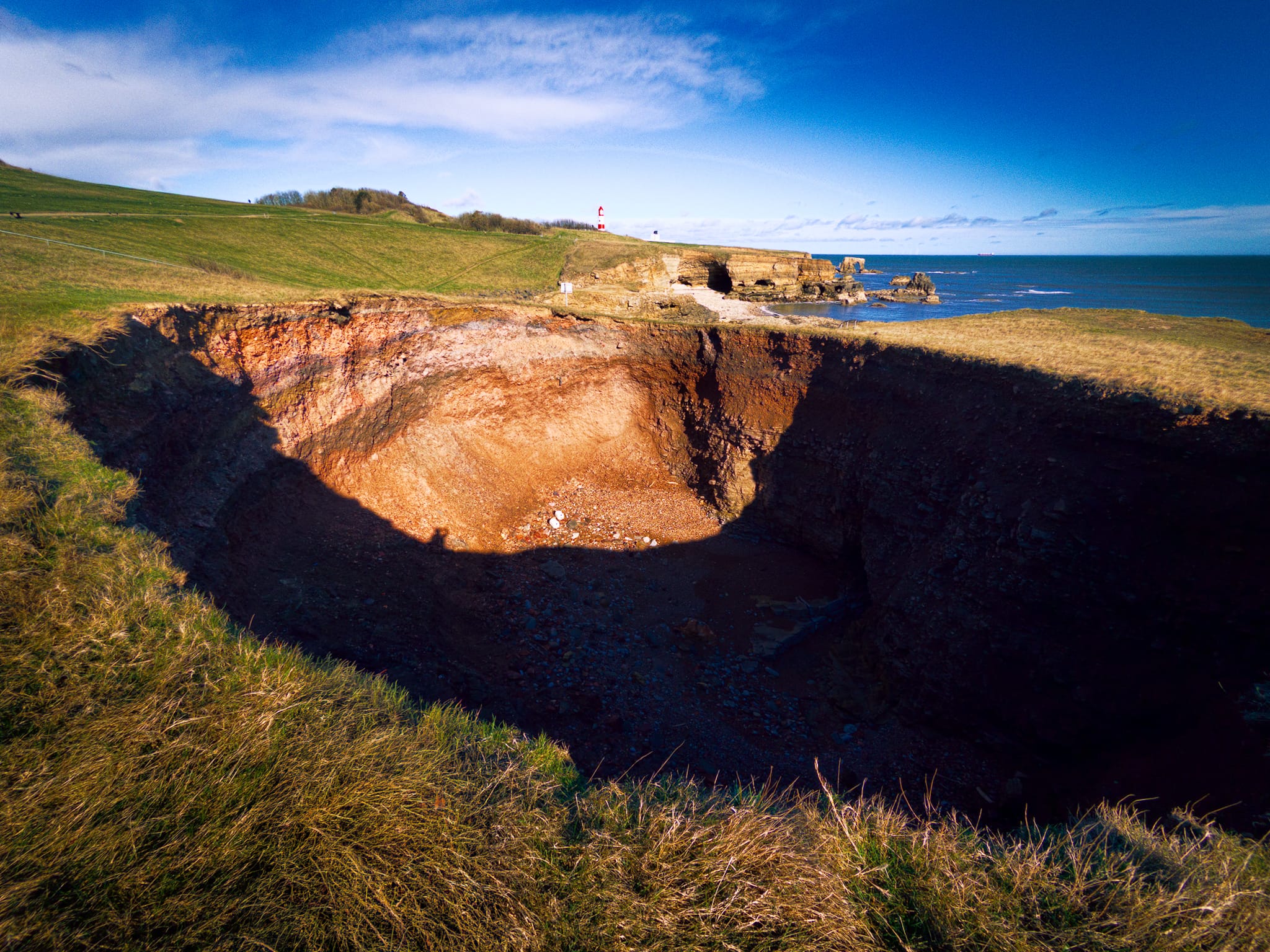 Further north I tentatively edged closer to this massive hole, apparently called Potter&rsquo;s Hole. It&rsquo;s a little away from the cliffs, but in time I&rsquo;m sure this hole will join the sea and form a bay.
