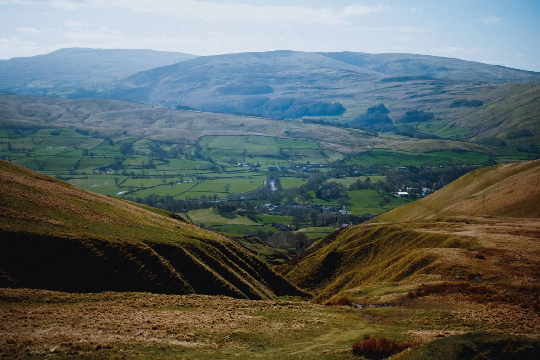  One last look back down, with the full extent of Settlebeck Gill below, the Sedbergh countryside in the middle distance, and the Dentdale fells of the Yorkshire Dales in the background. 